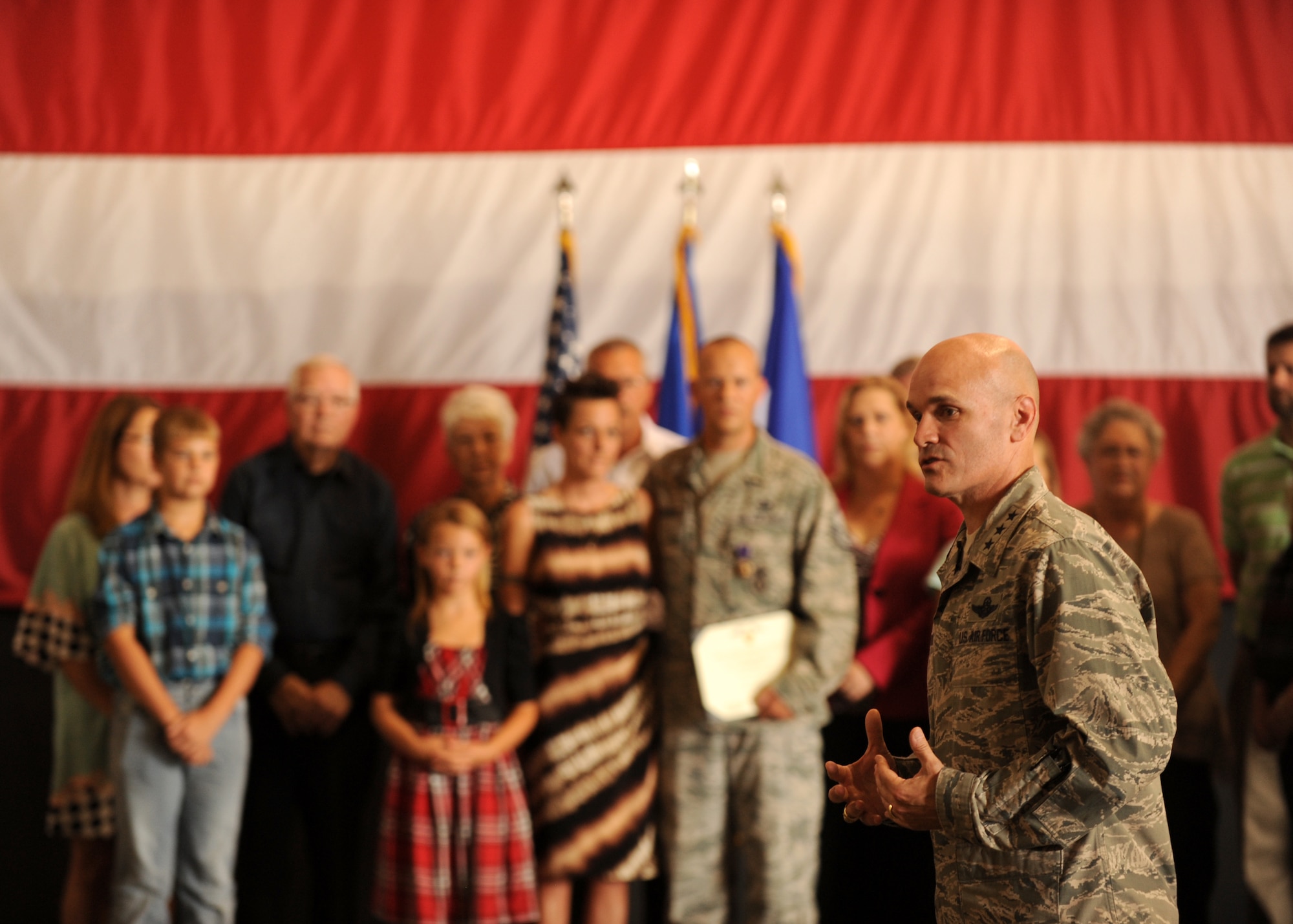 Lt. Gen. Carlton D. Everhart II, 18th Air Force commander, thanks Master Sgt. Aaron Downing, a 19th Security Forces Squadron noncommissioned officer-in-charge of operations for his and his family’s service and sacrifices Sept. 5, 2014, at Little Rock Air Force Base, Ark. Downing was recognized during a Purple Heart presentation for injuries he sustained from an improvised explosive device while in a deployed location July 28, 2007. (U.S. Air Force photo by Airman 1st Class Scott Poe)