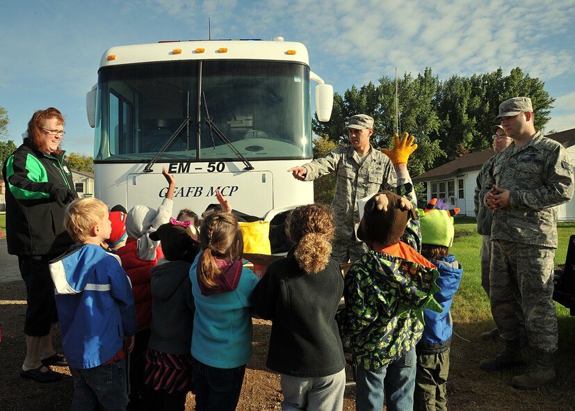 Staff Sgt. Shaun Zinner, 319th Civil Engineer Squadron NCO in charge of plans and operations, picks a pre-kindergarten student from Emerado Elementary School to answer a question dealing with emergency Management during National Preparedness Month Sept. 11, 2014, in Emerado, N.D. Throughout the month of September, the 319th CES EM team will visit schools to hand out pamphlets, goody bags and answer questions people may have regarding emergency preparedness. (U.S. Air Force photo/Senior Airman Xavier Navarro)