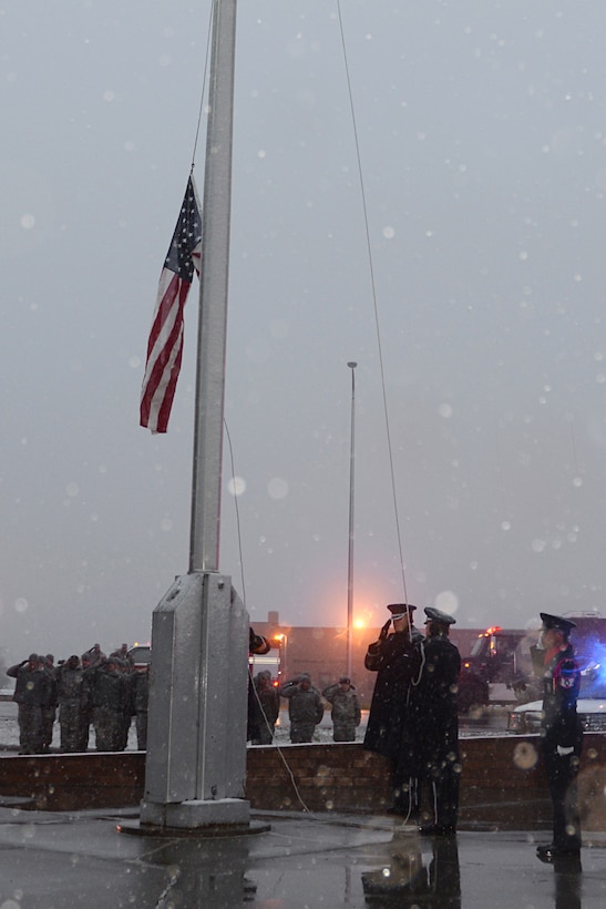Ellsworth Honor Guard members raise the flag to half staff during a special 9/11 reveille ceremony at the base flagpole at Ellsworth Air Force Base, S.D., Sept. 11, 2014. During the ceremony, the flag was lowered to half staff to honor of the lives lost in wartime and during the attacks on Sept. 11, 2001. (U.S. Air Force photo by Airman 1st Class Rebecca Imwalle/ Released)