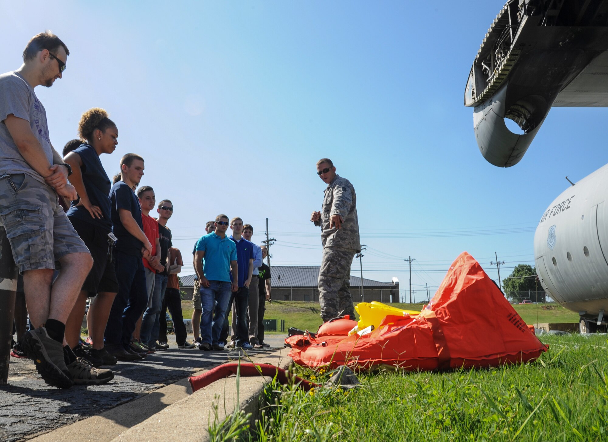 Tech Sgt. Paul McArdle, 19th Operations Support Squadron aircrew flight equipment supervisor, educates men and women enrolled in the Delayed Entry Program on a variety of life-saving devices found in many Air Force cargo planes Aug. 21, 2014, at Little Rock Air Force Base, Ark. Some of the DEP members will become aircrew Airmen after their initial training. (U.S. Air Force photo by Airman 1st Class Harry Brexel)
