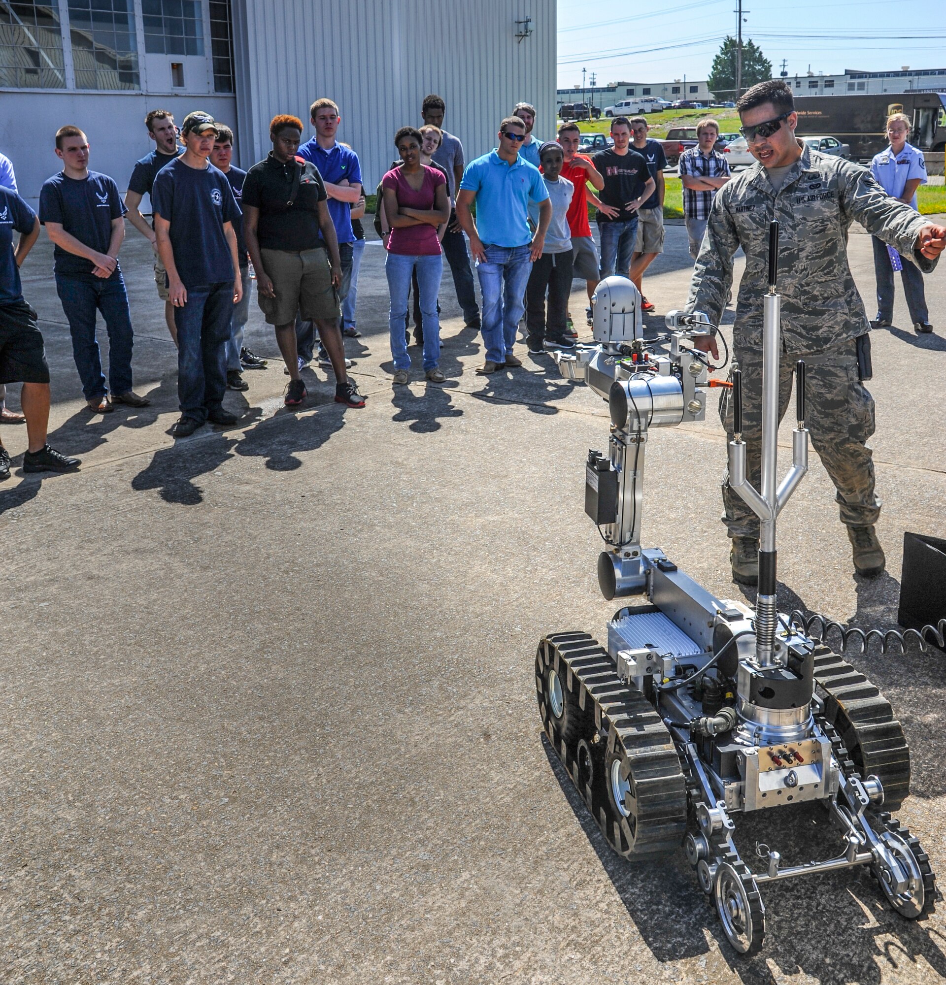 Airman 1st Class Jacob Martinez, a 19th Civil Engineer Squadron explosive ordnance disposal technician, showcases a remote-controlled robotic device used to diffuse explosives Aug. 21, 2014, at Little Rock Air Force Base, Ark. Martinez explained to the Air Force recruits what the job of an EOD technician entails. (U.S. Air Force photo by Airman 1st Class Harry Brexel)