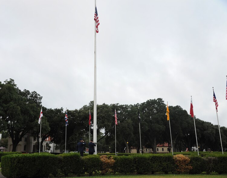 Barksdale Airmen raise the flag during the 9/11 Remembrance Ceremony on Barksdale Air Force Base, La., Sept. 11, 2014. Members of Team Barksdale gathered around the 2nd Bomb Wing Headquarters to honor those who lost their lives on Sept. 11, 2001 and two Airmen for their actions in support of Operation Enduring Freedom. (U.S. Air Force photo/Senior Airman Jannelle Dickey)
