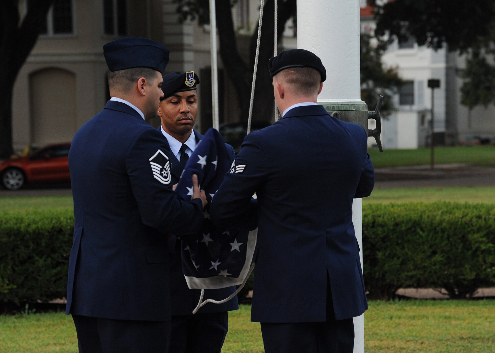 Barksdale Airmen prepare to raise the flag during the 9/11 Remembrance Ceremony on Barksdale Air Force Base, La., Sept. 11, 2014. The Airmen prepared and raised the flag to remember the 13th anniversary of 9/11. (U.S. Air Force photo/Senior Airman Jannelle Dickey)