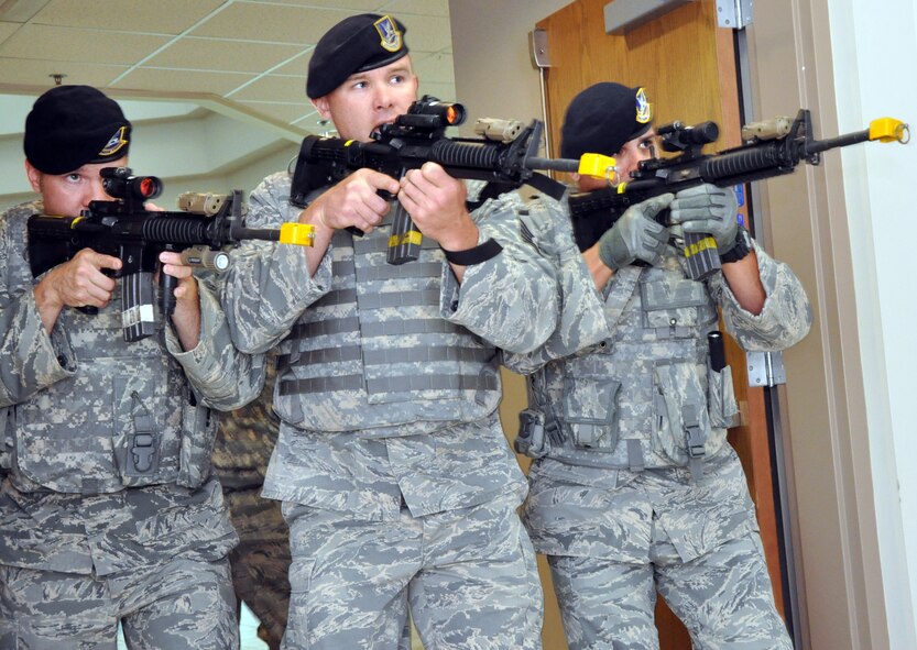 (From left to right) Tech. Sgt. James A. Stamos , Master Sgt. Michael Benning, and Tech. Sgt. Aaron S. Lopez, members of the 911th Airlift Wing Security Forces Squadron sweep a hallway during an active shooter exercise at the T./Sgt. Vernon McGarity U.S. Army Reserve Center, Sept. 10, 2014. The exercise was the first of its kind at the reserve center, and was aimed at training reserve center members on how to react in the event of an active shooter, making sure communication stayed flowing during such a situation, and also a law enforcement aspect of neutralizing the active shooter. Every branch of the U.S. military is focused on their people and performs training like this active shooter exercise to ensure their people know what to do in the event this would happen. 