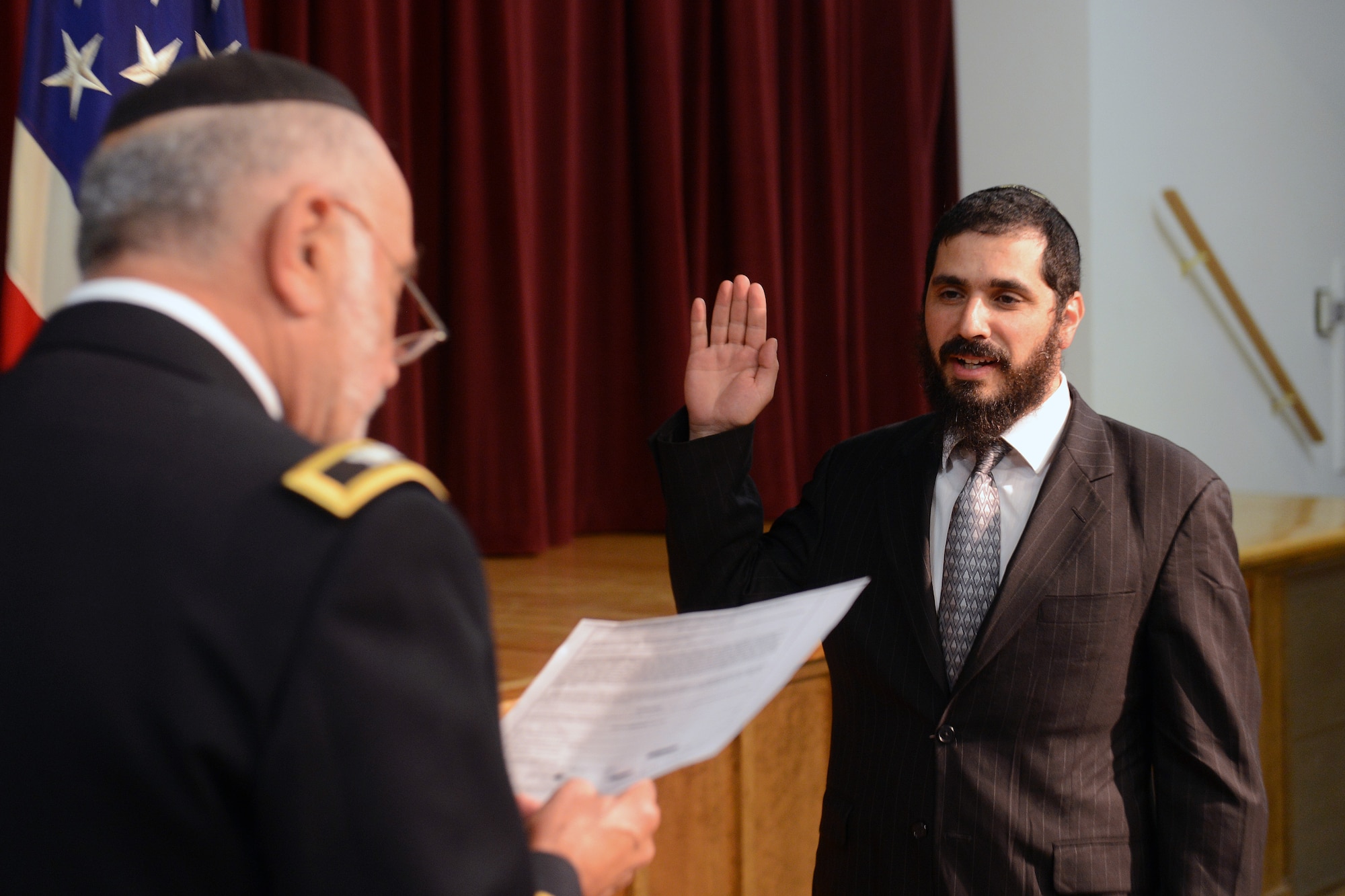 Retired U.S. Army Col. Sanford Dresin (left), swears in Capt. Elie Estrin, 627th Air Base Group chaplain Sept. 10, 2014, at Joint Base Lewis-McChord, Wash. Estrin is the first Hasidic Orthodox rabbi to join the Air Force as a chaplain. (U.S. Air Force photo/Airman 1st Class Jacob Jimenez)