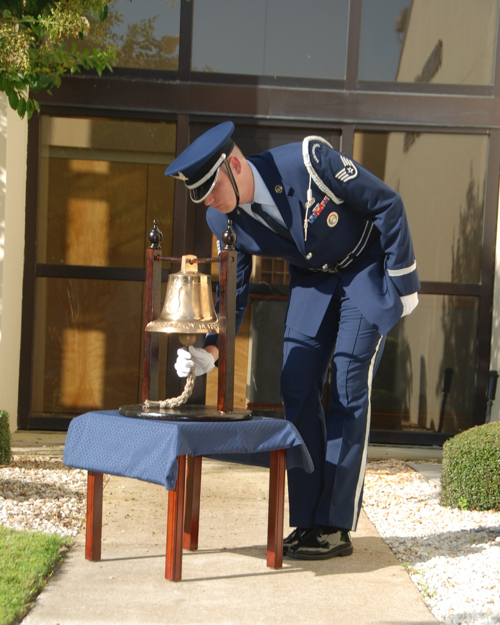 U.S. Air Force Staff Sgt. Matthew Hordeski, a member of the 601st Air and Space Operations Center Color Guard, rings a bell prior to a moment of silence during a memorial service Sept. 11, 2014, in front of the 601st AOC at Tyndall Air Force Base, Fla. The 601st AOC held a ceremony to honor the memory of those who lost their lives during the tragic events of Sept. 11, 2001. (Air National Guard photo by Capt. Jared Scott/Released)
