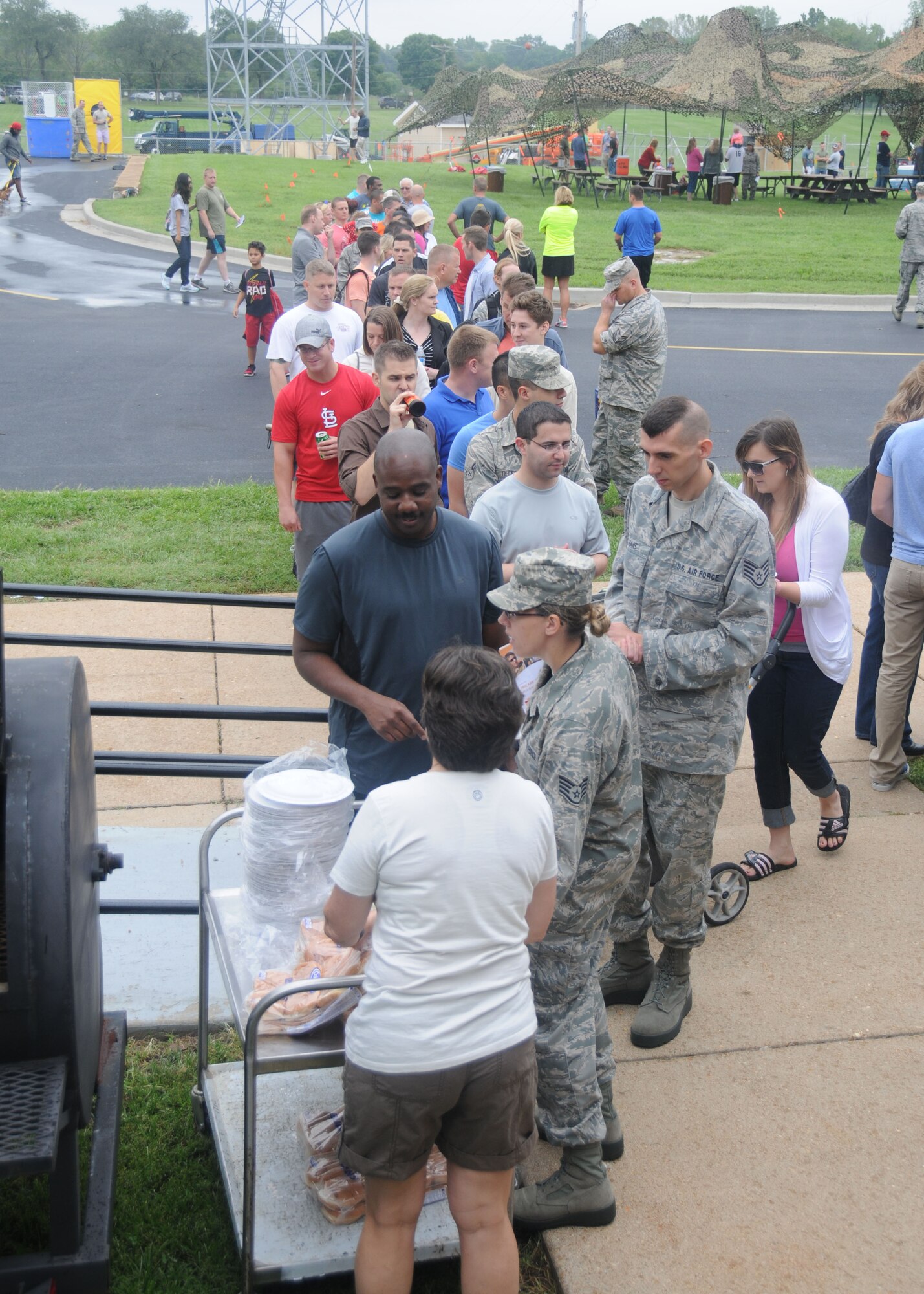Missouri Air National Guardsmen and their Families line up to take advantage of the burgers and hot dogs grilled by the 131st Bomb Wing Chiefs Council during the Annual Jefferson Barracks Family Day event in St. Louis, Missouri on Sept. 6, 2014. (U.S. Air National Guard photo by Senior Airman Nathan Dampf)