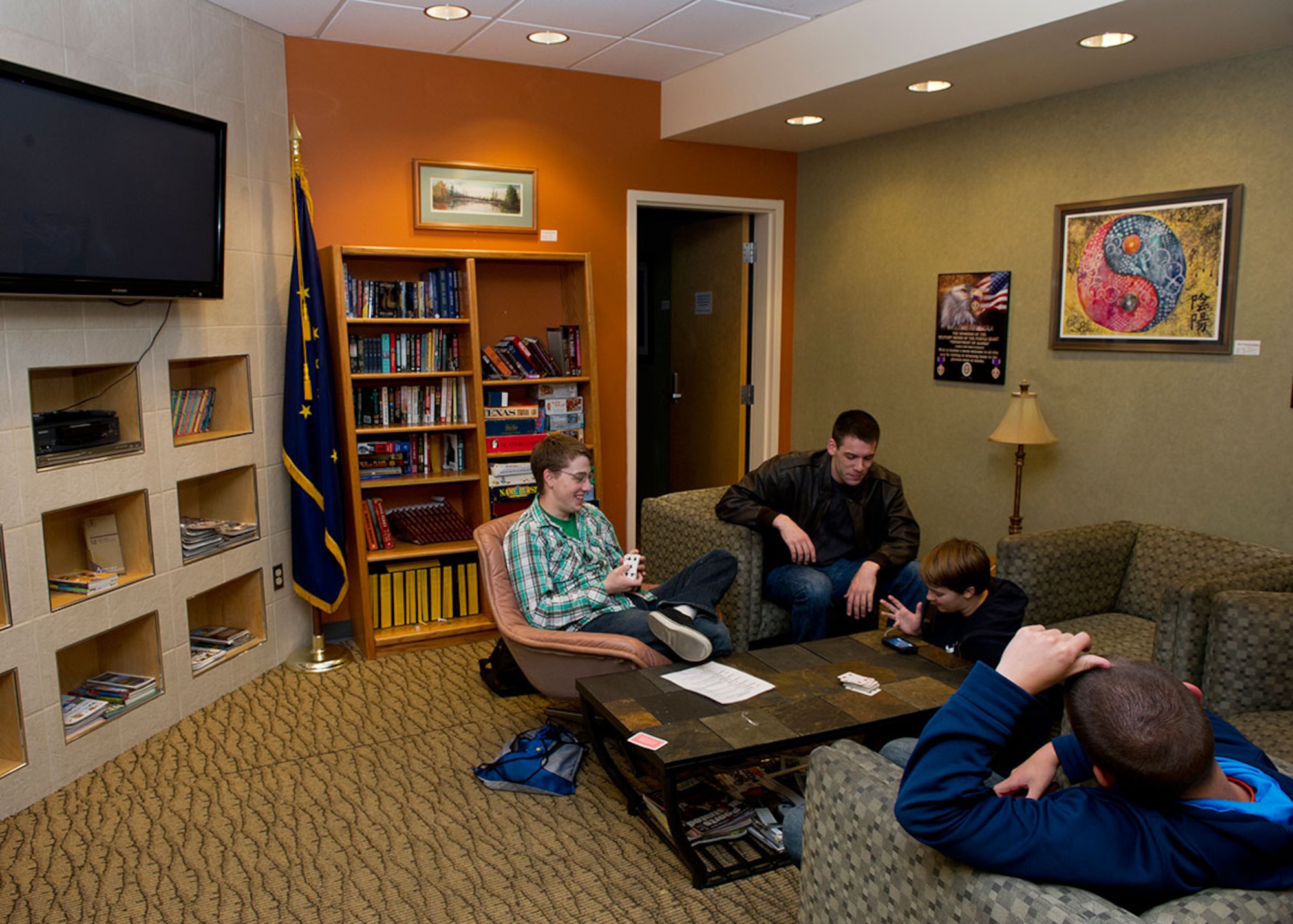 Four military trainees relax at the Atwood Lounge in the Ted Stevens International Airport as they wait on their flights to Air Force and Navy basic training, August 27, 2014. The Atwood Lounge is run by the Armed Services YMCA of Alaska and is a place for service members and their families to relax while awaiting flights in the Ted Stevens International Airport. (U.S. Air Force photo/ Senior Airman Omari Bernard)