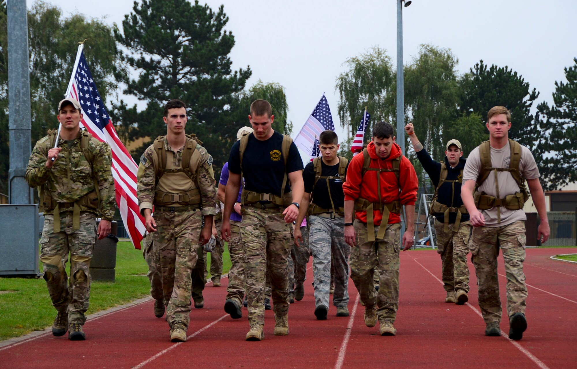 Airmen from the 48th Civil Engineer Squadron Explosive Ordnance Disposal flight participate in a 9/11 Memorial 5K Run/Walk “Moving Tribute” at Royal Air Force Lakenheath, England, Sept. 11, 2014. Many of the participants ran or walked with American flags to show their respect for those who lost their lives during the tragic events that occurred 13 years ago. (U.S. Air Force photo by Airman 1st Class Erin O’Shea/Released)