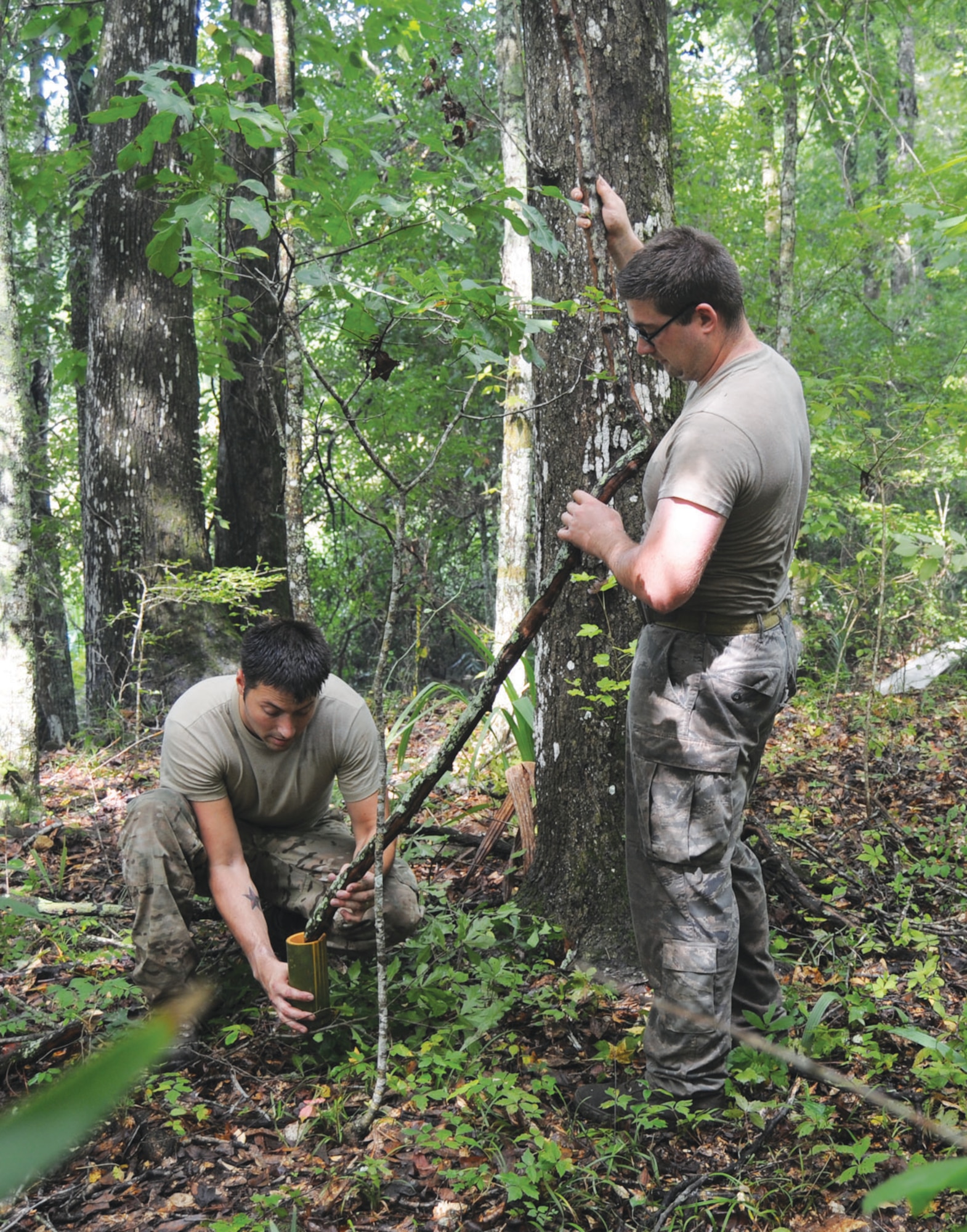 Students collect water from a water vine into a segment of bamboo during a tropical survival exercise in the Atchafalaya Basin Aug. 30-Sept. 1.  (U.S. Army photo by Jean Dubiel)