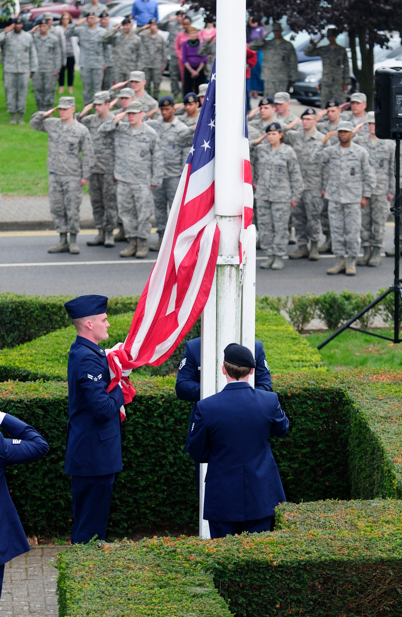 First responders from RAF Mildenhall and RAF Lakenheath lower the U.S. flag during a 9/11 memorial retreat ceremony Sept. 11, 2014, on RAF Mildenhall, England. This year marks the 13th anniversary of the attacks on the World Trade Center in New York City. (U.S. Air Force photo/Karen Abeyasekere/Released) 