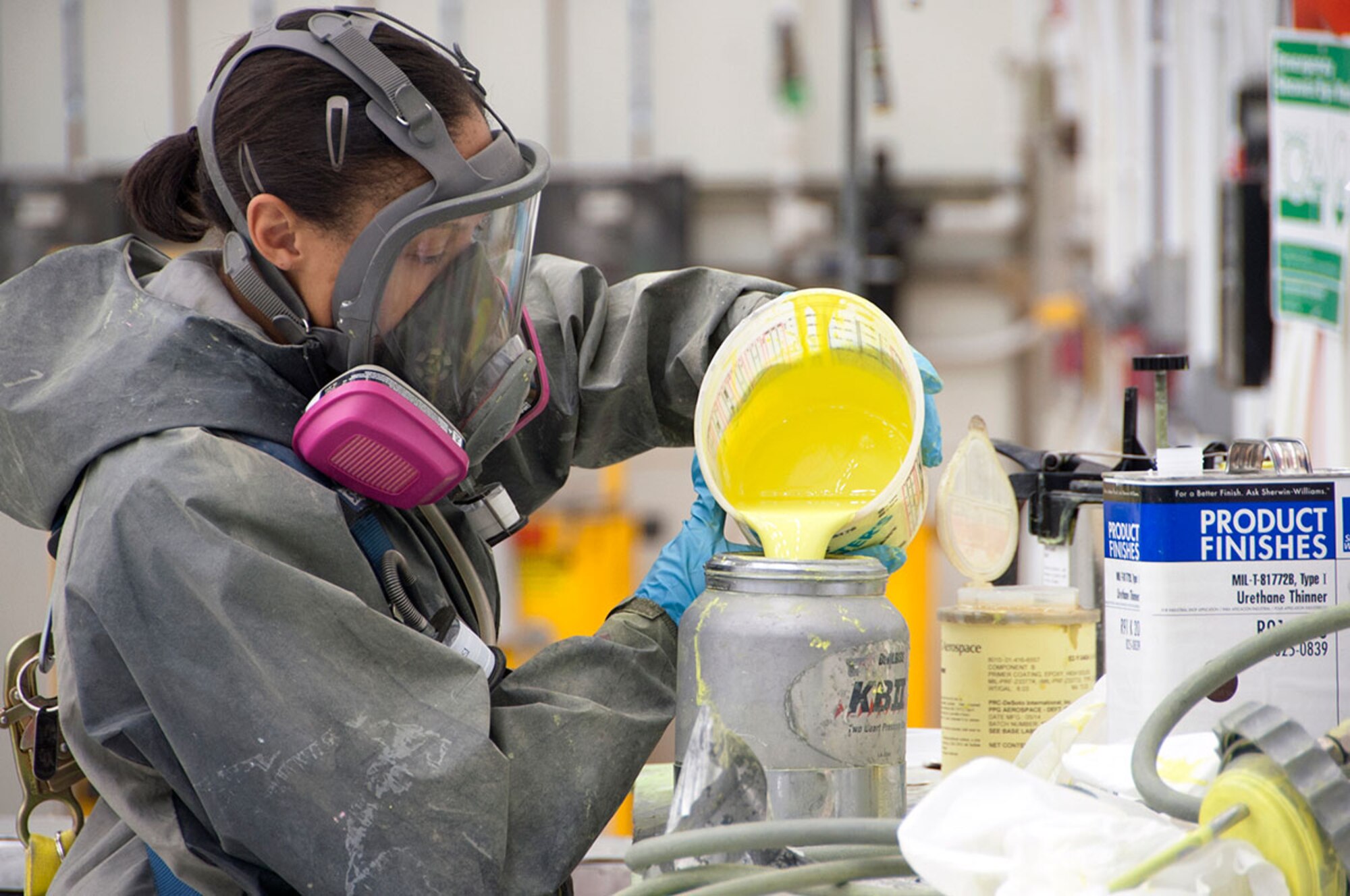 Airman 1st Class Shaivia Gore, 3rd Aircraft Maintenance Squadron aircraft maintenance apprentice, pours primer in a paint sprayer on Joint Base Elmendorf-Richardson, Alaska, Sept. 4, 2014. The primer allows the paint to adhere to the plane better and lasts longer in the outdoor elements. (U.S. Air Force photo/Airman 1st Class Tammie Ramsouer)