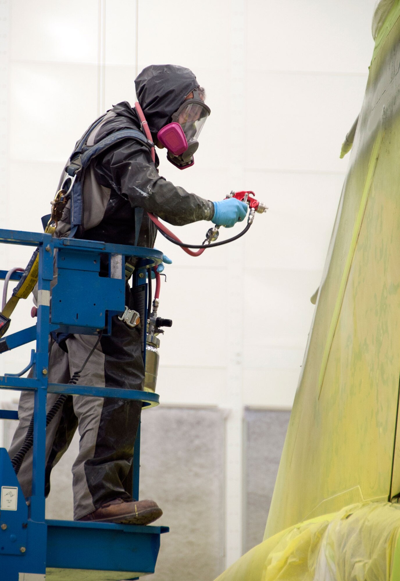 Marc Horn, 3rd Aircraft Maintenance Squadron aircraft maintenance technician, paints an F-4 Phantom II on Joint Base Elmendorf-Richardson, Alaska, Sept. 9, 2014.  To prevent inhalation of chemicals, Airmen must wear respirators while painting any aircraft although, the hangar is well ventilated. The 3rd AMXS refurbishes the static aircraft around JBER every 15 to 20 years. (U.S. Air Force photo/Airman 1st Class Tammie Ramsouer)