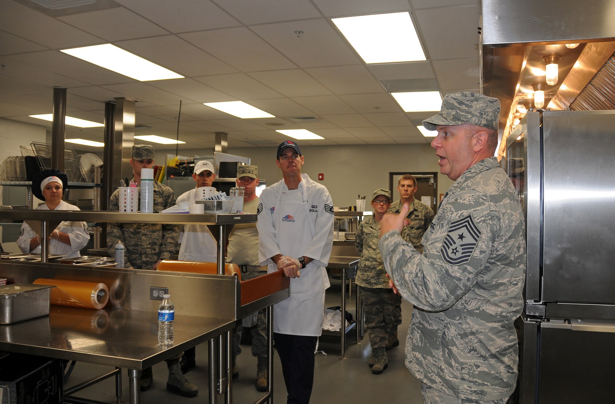 Command Chief Master Sergeant of the Air National Guard James W. Hotaling (far right) speaks with members of the 190th Air Refueling Wing Force Support Sustainment Squadron. (L to R) Tech. Sgt. Danielle Sumpter, Airman 1st Class Zack Doty, Senior Airman Amaury Marquez-Vazquez, Senior Airman Ross Ackley, Staff Sgt. Jason Dolan, Tech. Sgt. Nikki Meyer, Airman 1st Class Tyler Bartee, Sept. 6, 2014.  (U.S. Air National Guad photo by Tech. Sgt. Mandy Johnson)