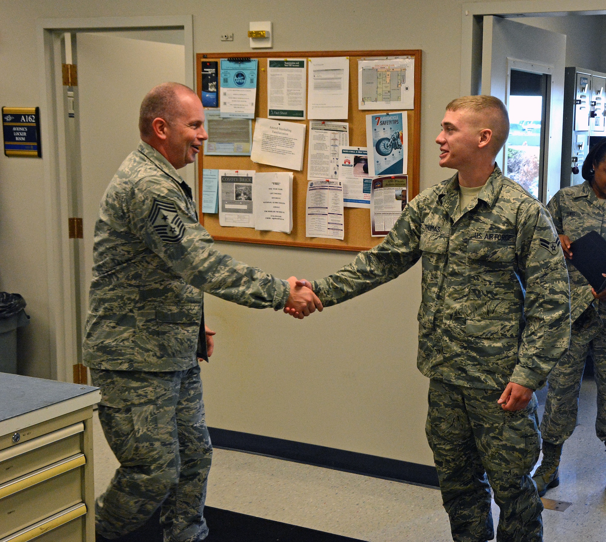 Command Chief Master Sergeant of the Air National Guard James W. Hotaling greets Airman 1st Class Ryan Thomas from the 190th Air Refueling Wing during Chief Hotaling's visit to Forbes Field, Topeka, Kansas Sept. 6, 2014. (U.S. Air National Guard photo by Master Sgt. Allen Pickert)
