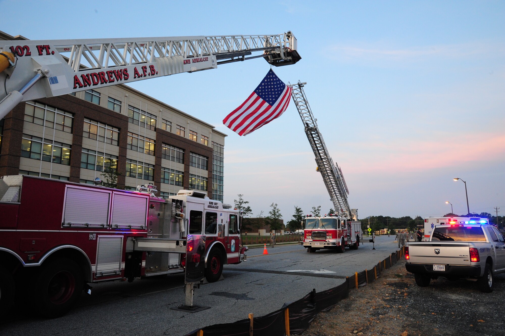 Team Andrews first responders fly an American flag during morning reveille on Sept 11, 2001 at Joint Base Andrews, Md. The morning reveille paid respect to all those who lost their lives in the Sept. 11, 2001 attacks. (U.S. Air Force photo/Airman 1st Class J.D. Maidens)