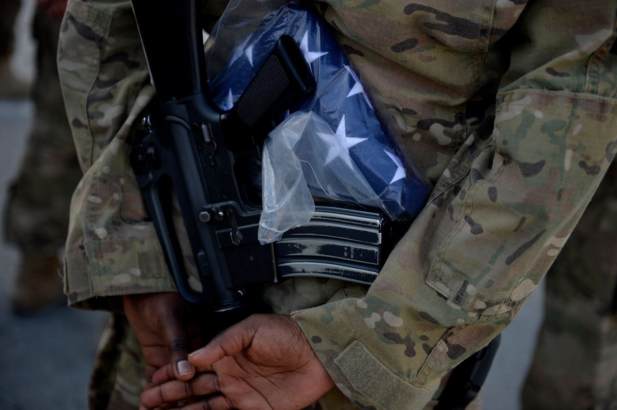 U.S. Air Force Airman assigned to the 455th Air Expeditionary Wing stands in formation during a retreat ceremony at Bagram Airfield, Afghanistan Sept. 11, 2014.  Airmen participated in a Patriot's Day Retreat and reenlistment ceremony Sept. 11, 2014.  Patriot's Day is an annual observance to remember those who were injured or died during the attacks on Sept. 11, 2001. (U.S. Air Force photo by Staff Sgt. Evelyn Chavez/Released)