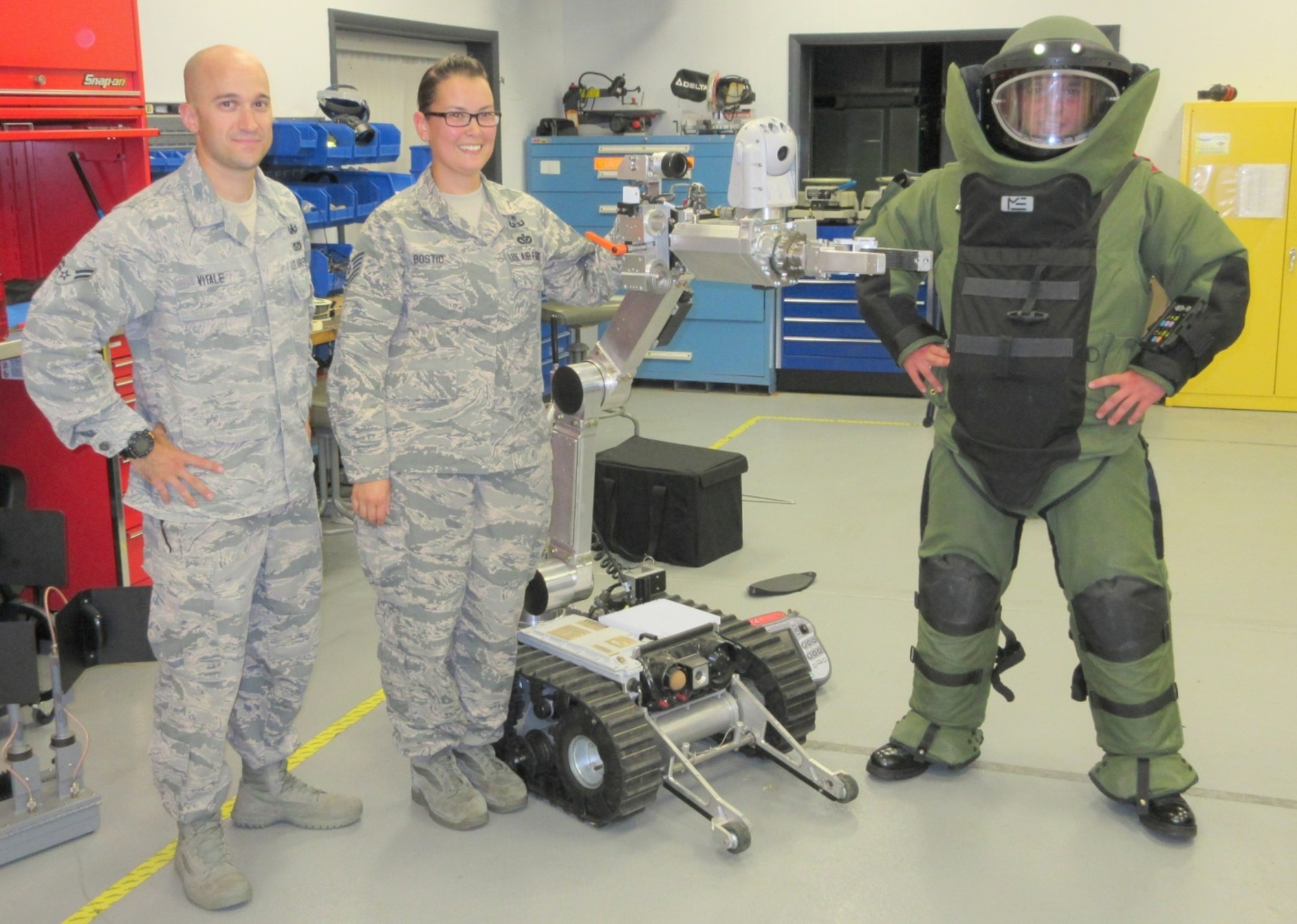 Airman 1st Class Andrew Vitale and Tech. Sgt. Sue Bostic, 436th Civil Engineer Squadron explosive ordnance disposal flight, pose with Cadet Tech. Sgt. Preston J. Border, Civil Air Patrol Delaware Wing Eagle Cadet Squadron, Sept. 8, 2014, at Dover Air Force Base, Del. (Courtesy photo/Civil Air Patrol Capt Scott T. Tuson, Delaware Wing)