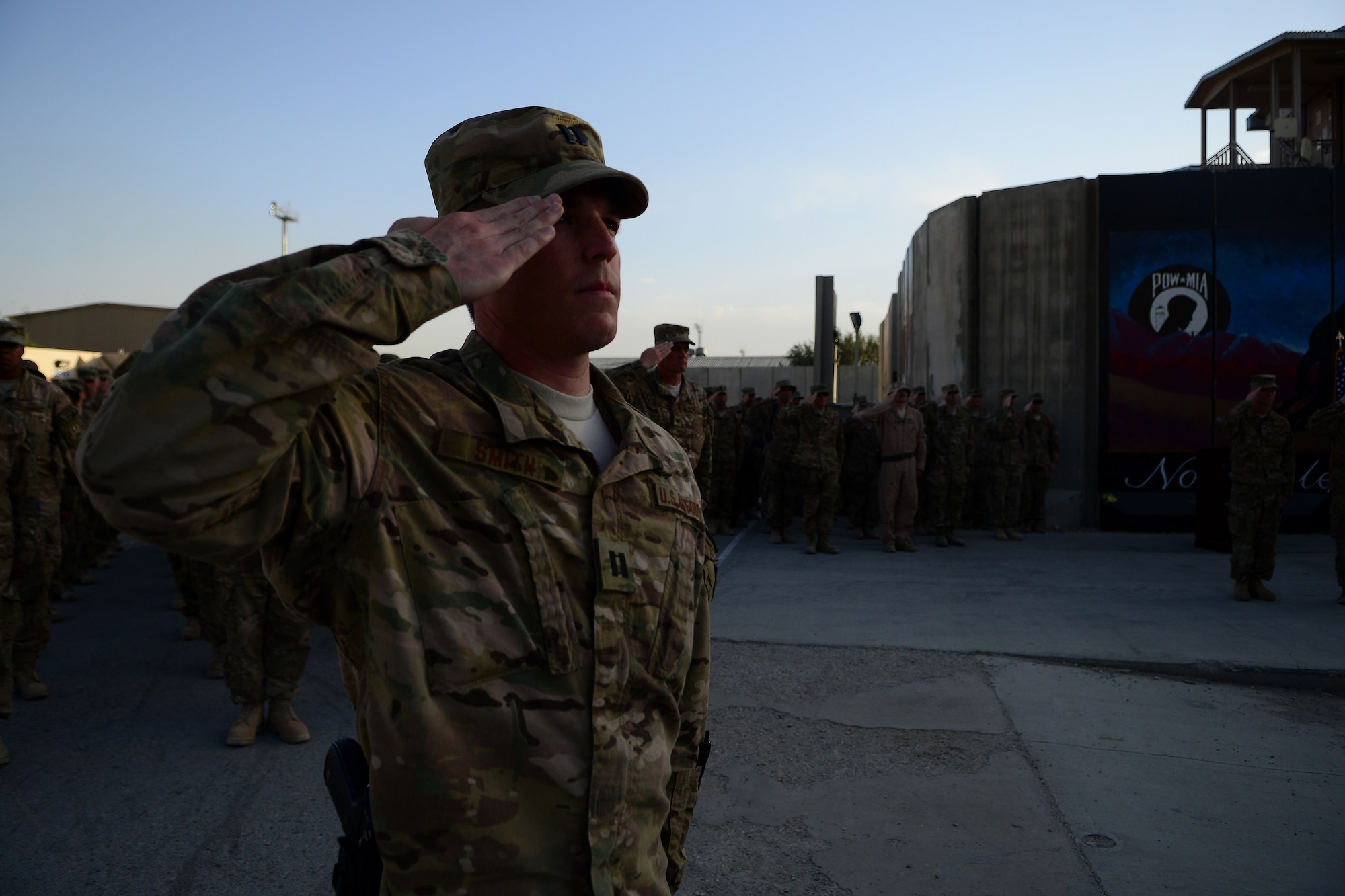 U.S. Air Force Capt. John Smith,  455th Expeditionary Medical Operations Squadron, salutes during a retreat ceremony at Bagram Airfield, Afghanistan Sept. 11, 2014.  Airmen participated in a Patriot's Day Retreat and reenlistment ceremony Sept. 11, 2014.  Patriot's Day is an annual observance to remember those who were injured or died during the attacks on Sept. 11, 2001. (U.S. Air Force photo by Staff Sgt. Evelyn Chavez/Released)