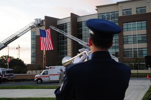 An Air Force Band Member plays taps during morning reveille on Sept. 11, 2014 at Joint Base Andrews, Md. The morning reveille paid respect to all those who lost their lives in the Sept. 11, 2001 attacks. (U.S. Air Force photo/Airman 1st Class J.D. Maidens)
