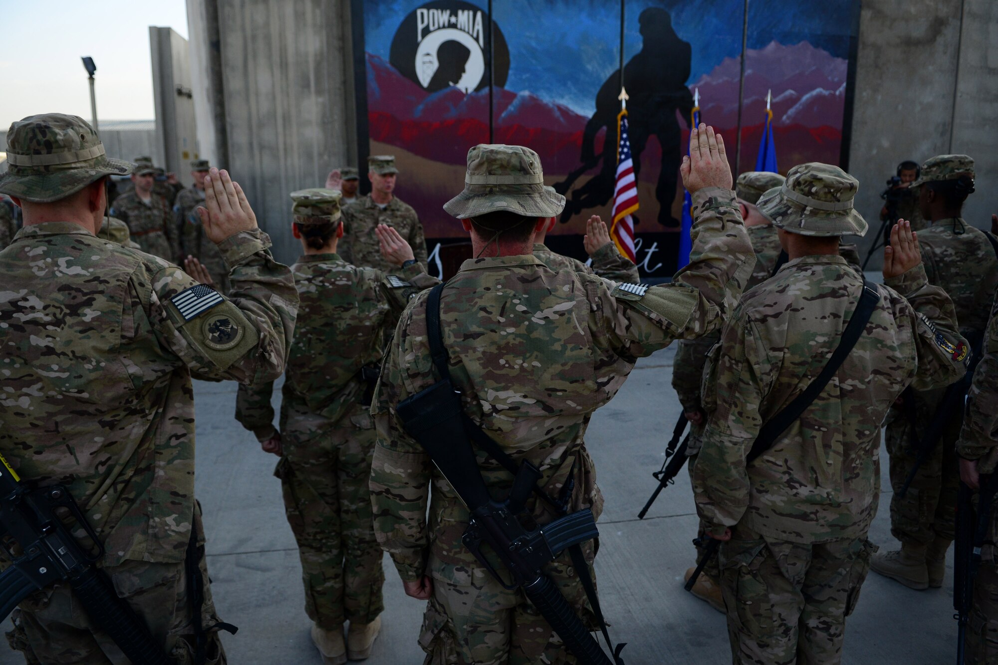 U.S. Airmen assigned to the 455th Air Expeditionary Wing take reenlistment oath during a Patriot's Day ceremony at Bagram Airfield, Afghanistan Sept. 11, 2014.  Airmen participated in a Patriot's Day Retreat and reenlistment ceremony Sept. 11, 2014.  Patriot's Day is an annual observance to remember those who were injured or died during the attacks on Sept. 11, 2001. (U.S. Air Force photo by Staff Sgt. Evelyn Chavez/Released)