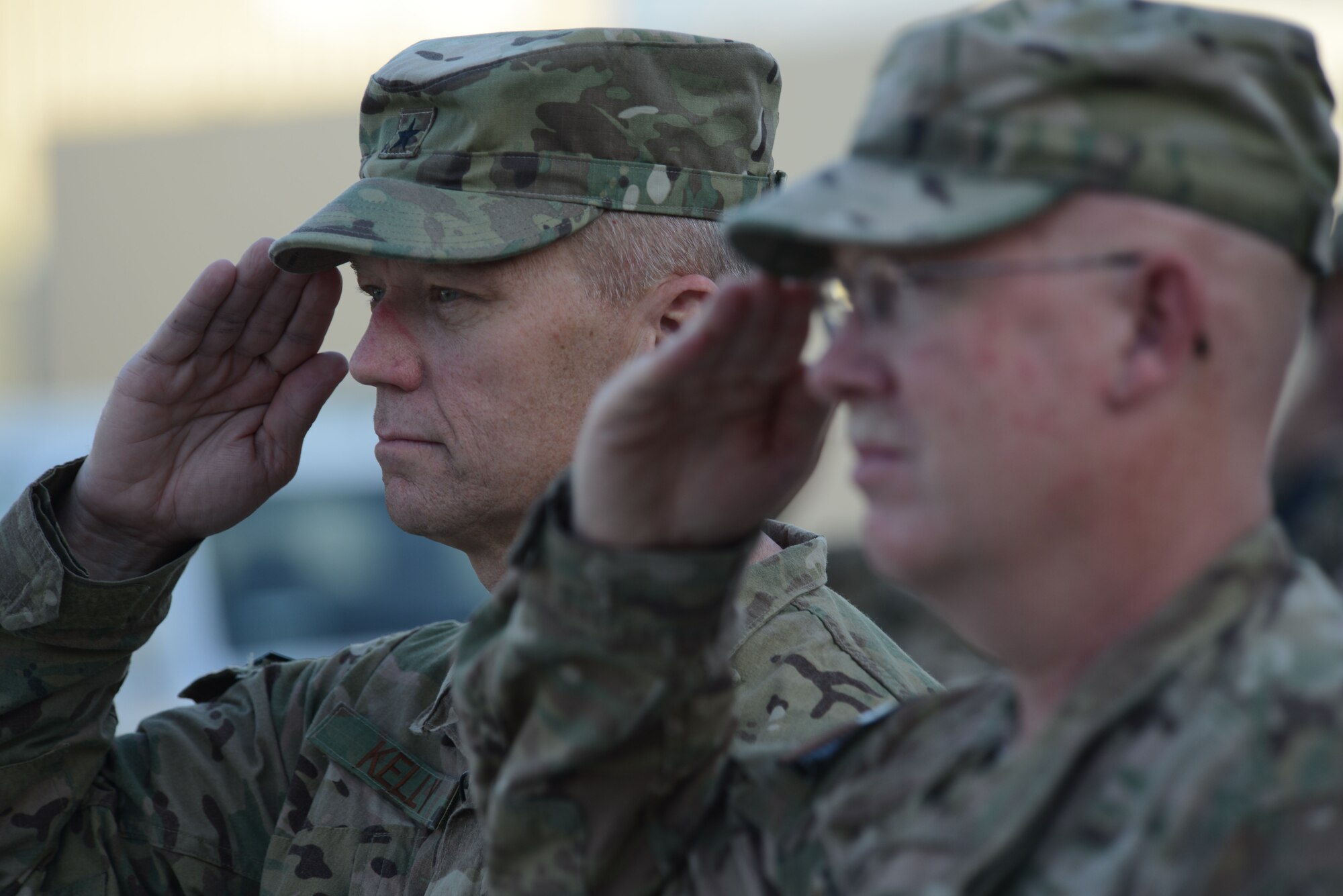 U.S. Air Force Brig. Gen. Mark D. Kelly, 455th Air Expeditionary Wing commander and Chief Master Sgt. Jeffery Brown, 455 AEW command chief salute during a retreat ceremony commemorating Patriot Day Sept. 11, 2014 at Bagram Airfield, Afghanistan. Patriot Day is remembered globally as the anniversary of the terrorist attacks in the United States Sept. 11, 2001. (U.S. Air Force photo by Master Sgt. Cohen A. Young/Released)