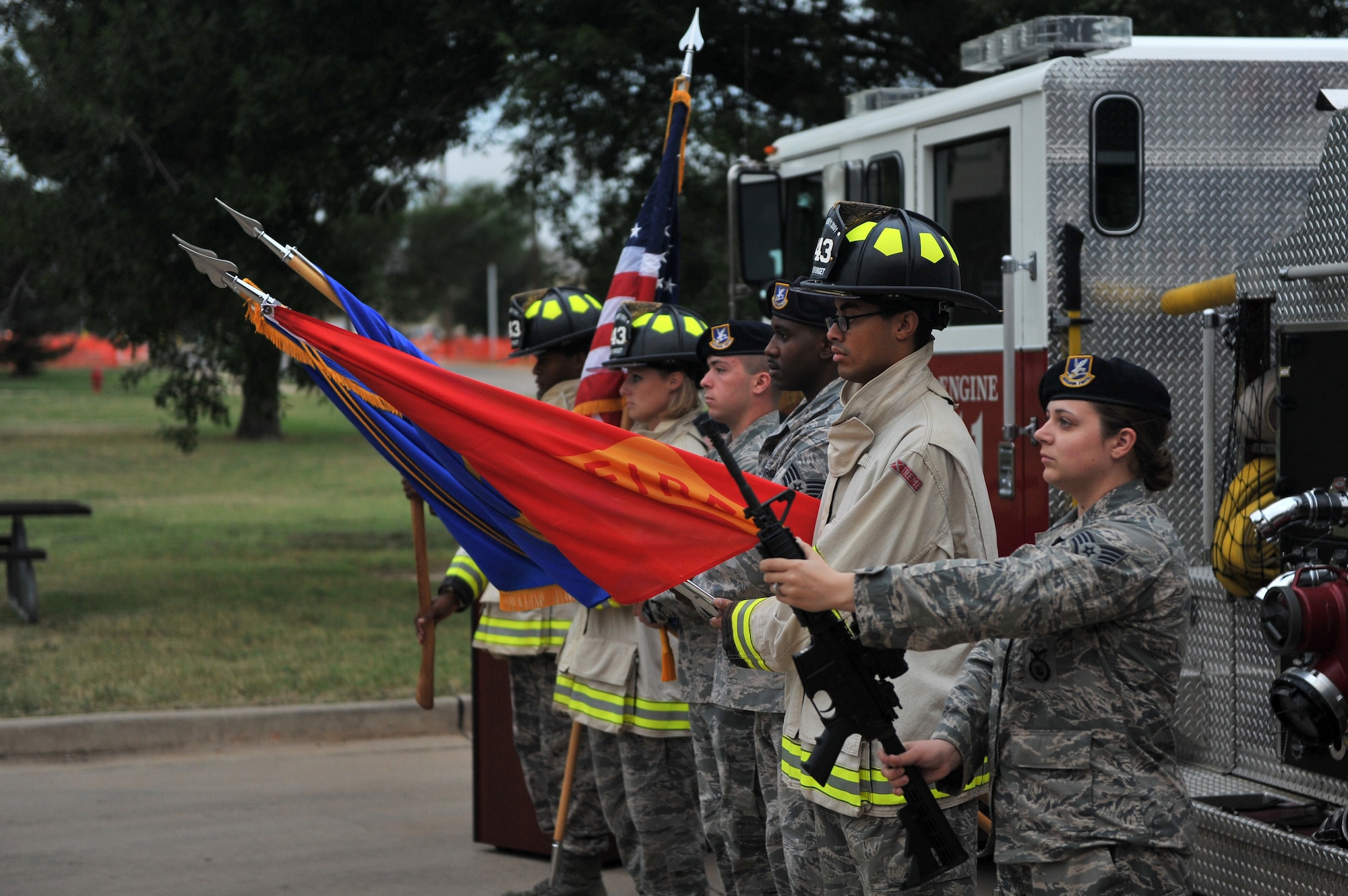 ALTUS AIR FORCE BASE, Okla. – Members of the 97th Security Forces Squadron and the 97th Civil Engineer Squadron present the colors during this year’s Patriot Day ceremony outside the base fire station Sept. 11, 2014. The ceremony was held to honor the 343 firefighters and 23 police officers lost during the tragic events on Sept. 11, 2001. (U.S. Air Force photo by Senior Airman Dillon Davis/Released)