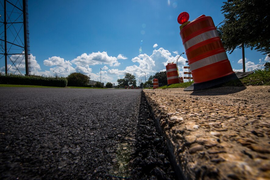 Traffic barrels mark a freshly paved road Sept. 3, 2014, at Moody Air Force Base, Ga. Moody’s road pavement repair project will impact traffic along Robbins, Kelly, Savannah and Robinson roads until January 2015. (U.S. Air Force photo by Airman 1st Class Ryan Callaghan/Released)