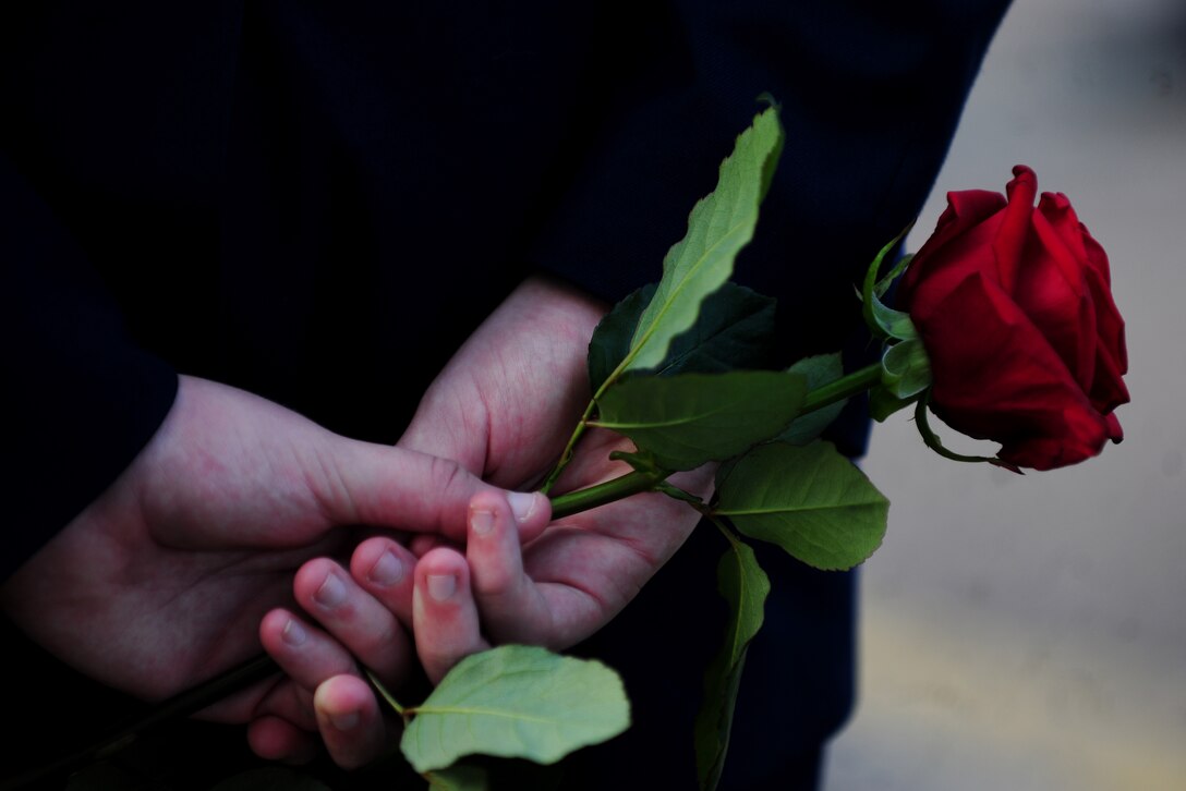 A U.S. Air Force Junior Reserve Officer Training Corps cadet from Alconbury High School, United Kingdom holds a rose during a 9/11 remembrance ceremony at RAF Alconbury, Sept. 11, 2014. Cadets laid roses at the school flagpole to signify their appreciation for the sacrifices emergency responders made during that fateful day 13 years ago. (U.S. Air Force photo by Staff Sgt. Jarad A. Denton/Released)