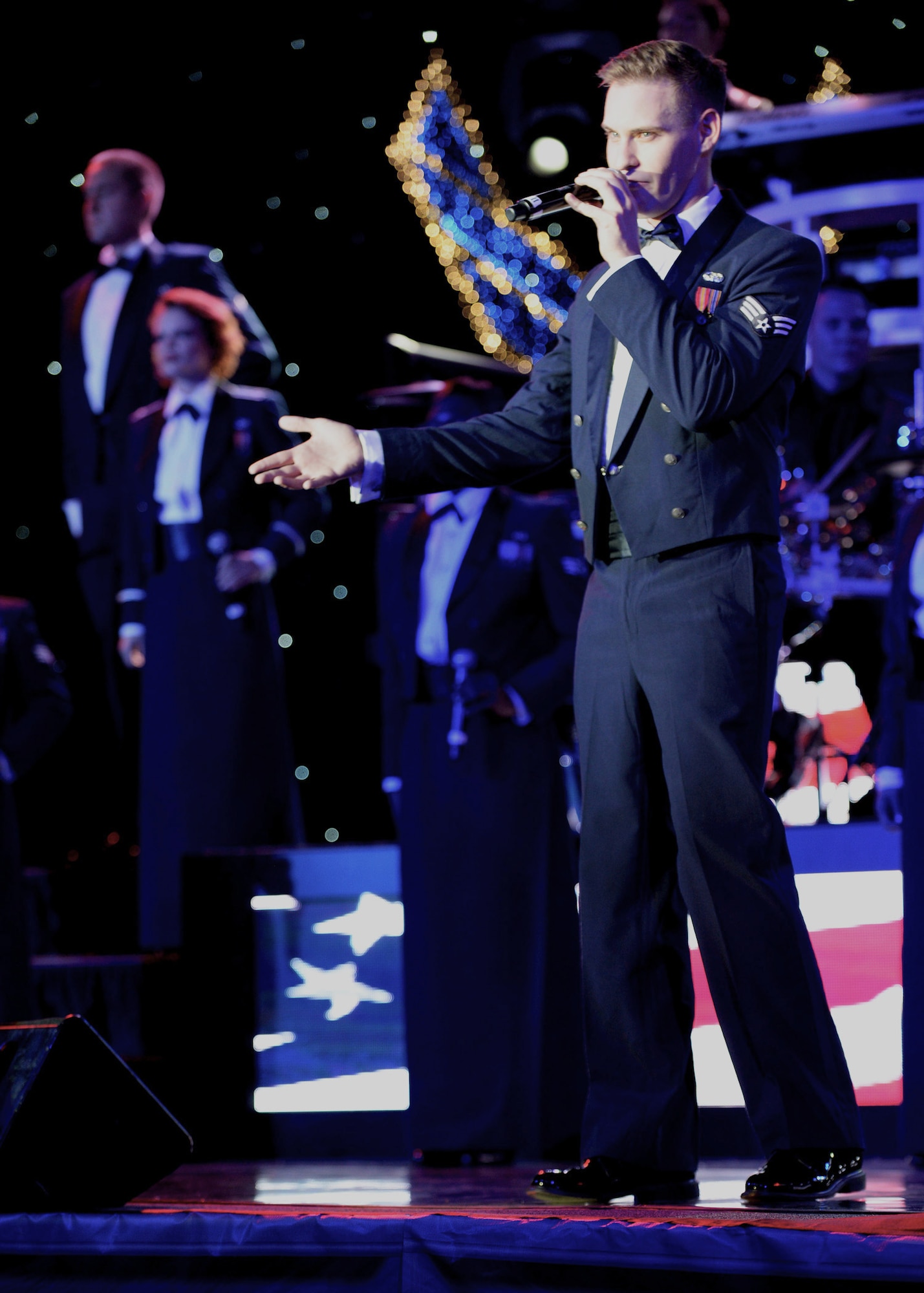 U.S. Air Force Senior Airman Jeremiah Barnes, a 56th Communications Squadron cyber systems operations journeyman assigned to Luke Air Force Base, Ariz., and native of Nashville, Tenn., sings during the Tops in Blue performance in the Skelton Memorial Fitness Center at Spangdahlem Air Base, Germany, Sept. 9, 2014. Tops in Blue members complete a nine-month temporary duty to the home of Tops in Blue, Lackland Air Force Base, Texas, including an intense 60-day training period before going on tour. (U.S. Air Force photo by Airman 1st Class Timothy Kim/Released)