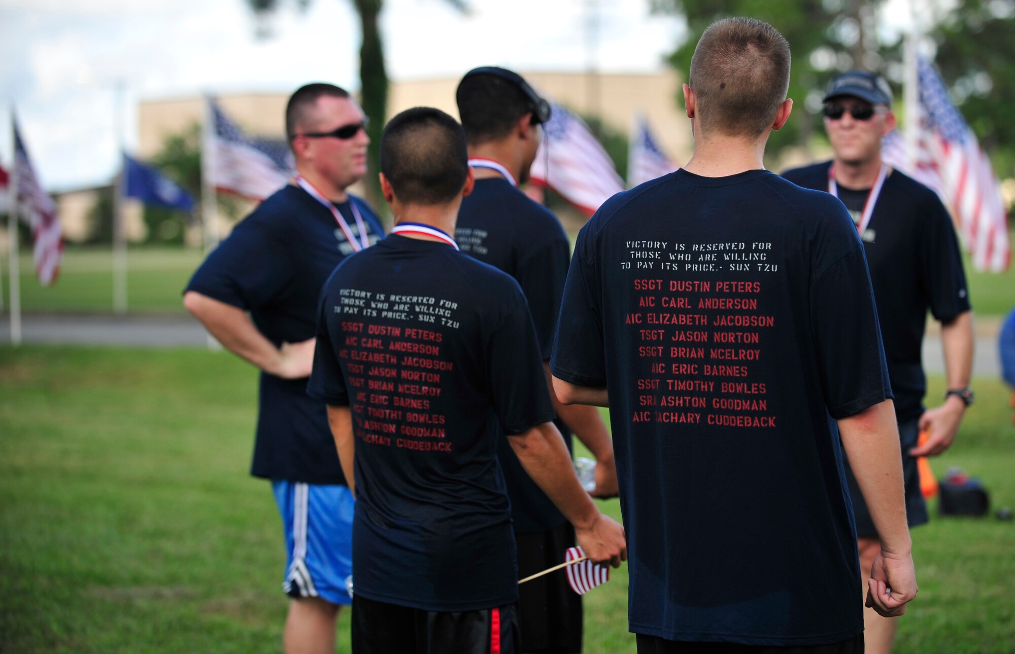 A group of runners, supporting fallen comrades in the field of vehicle operations and convoy movements, gathers after finishing the second annual Run for the Fallen 5K/Half-Marathon on Sept. 6 at Seymour Johnson Air Force Base, North Carolina. Military units participated in the run in support of fallen comrades within their specific career fields. One such group was the 4th Logistics Readiness Squadron, who honored those who’ve paid the ultimate sacrifice by wearing t-shirts with names of the fallen on the back. [Note: The Seymour Johnson Air Force Base Company Grade Officer's Council is a private organization. It’s not a part of the Department of Defense or any of its components and it has no governmental status] (U.S. Air Force photo/Airman 1st Class Shawna L. Keyes)