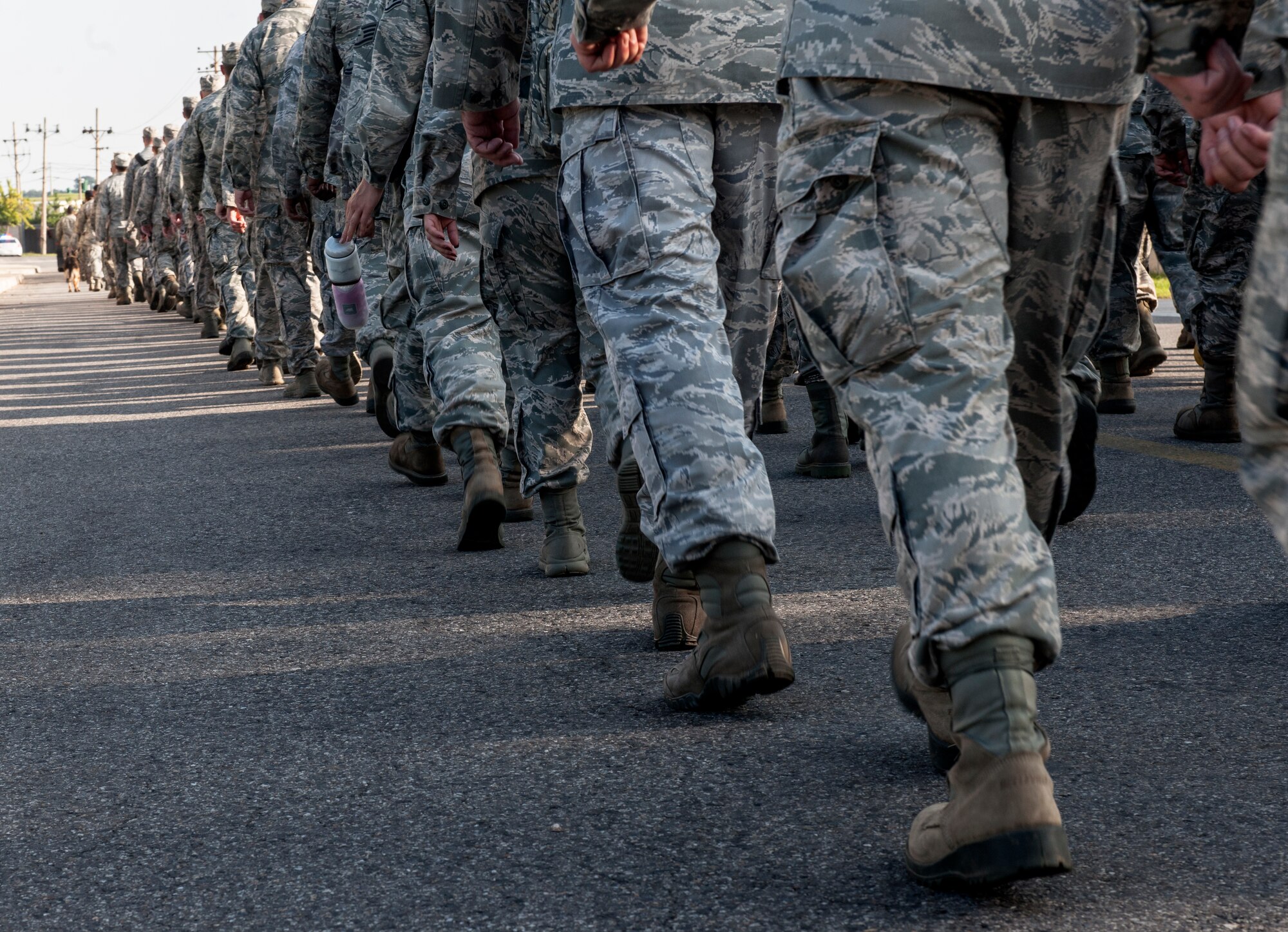 The Wolf Pack marches across base during a silent walk honoring the 13th anniversary of Sept. 11, 2001, at Kunsan Air Base, Republic of Korea. The event served not only to honor those who made the ultimate sacrifice, but also as a reminder to Wolf Pack Airmen of the American freedoms they ensure every day as defenders of the base against external threats in wartime and armistice alongside ROK allies. (U.S. Air Force photo by Senior Airman Katrina Heikkinen/Released)