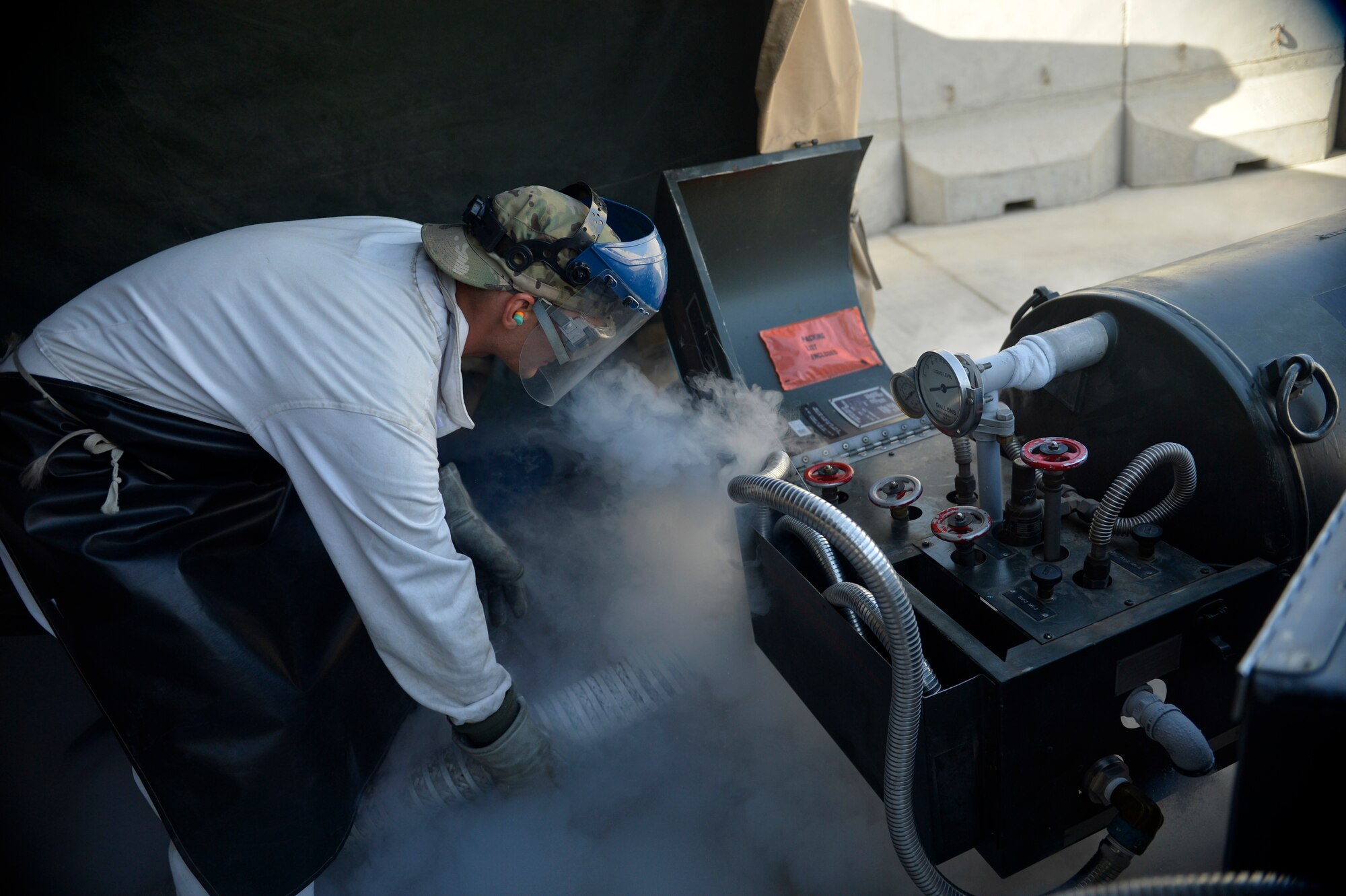 U.S. Air Force Staff Sgt. James Brumbaugh, 455th Expeditionary Logistics Readiness Squadron fuels cryogenics non-commisioned officer in-charge, refills a liquid oxygen cart at Bagram Airfield, Afghanistan Aug. 5, 2014. The cryogenics technicians support 6,000 aircraft missions and provide more than 4,000 gallons of liquid oxygen per month. Brumbaugh is deployed from Davis-Monthan Air Force Base, Ariz. and a native of Clarkrange, Tenn. (U.S. Air Force photo by Staff Sgt. Evelyn Chavez/Released)