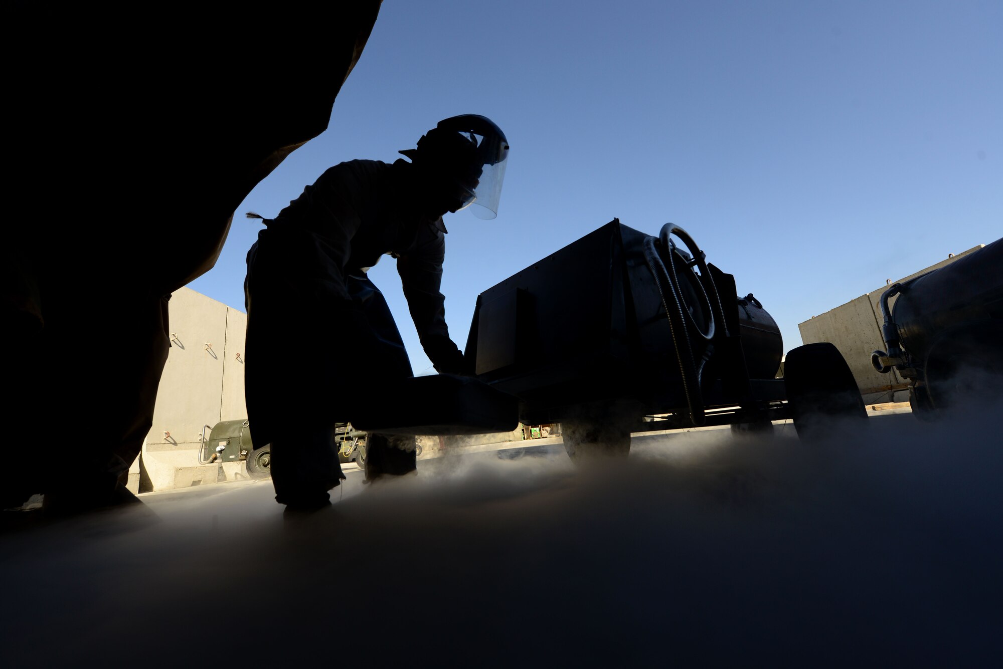 U.S. Air Force Staff Sgt. Taj Copeland, 455th   Expeditionary Logistics Readiness Squadron fuels distribution supervisor, moves a liquid oxygen cart at Bagram Airfield, Afghanistan Aug. 5, 2014.  Airmen with the cryogenics shop provide sustainable air for aircrew members to breathe at high altitudes.  Copeland is deployed from Nellis Air Force Base, Nev. and a native of Tampa, Fla. (U.S. Air Force photo by Staff Sgt. Evelyn Chavez/Released)