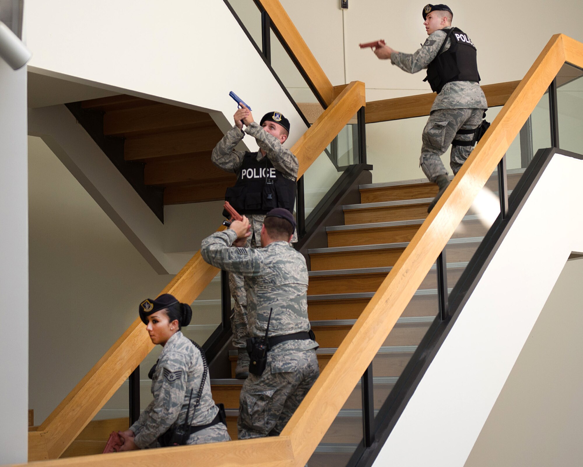 Staff Sgt. Cody Westbrook (from top to bottom), Tech. Sgt. John Twomey and Staff Sgts. Jacob White and Katherine Portes enter the lobby of the Brown Building during an active shooter exercise at Hanscom Air Force Base Sept. 5. The 66th Security Forces Squadron along with other agencies on base practiced their response to an active shooter incident as part of a base readiness exercise. (U.S. Air Force photo by Mark Herlihy)