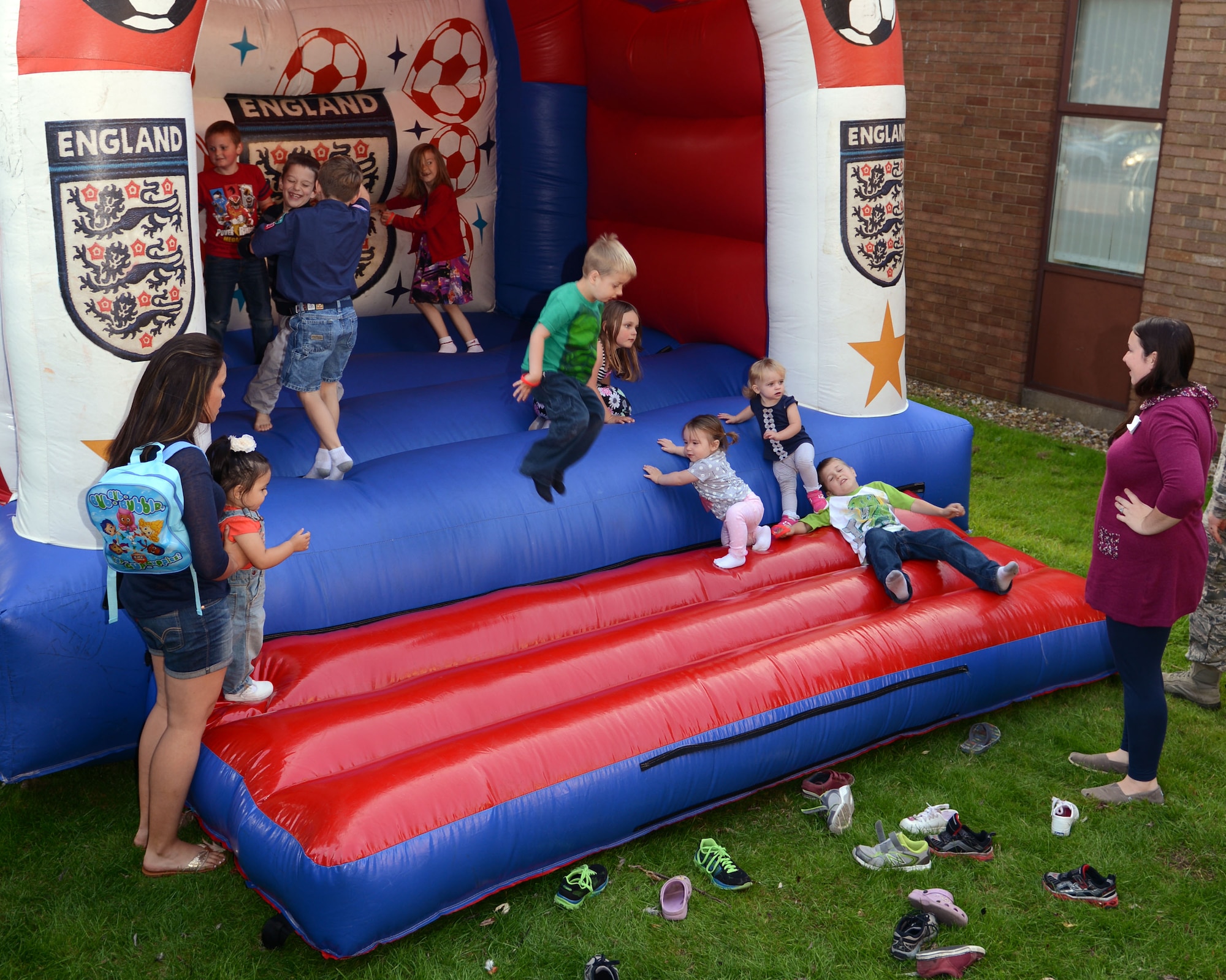 Team Mildenhall children play in a bouncy castle during a Hearts Apart event Sept. 10, 2014, at the chapel on RAF Mildenhall, England. A Hearts Apart event is held monthly for all families of deployed Airmen to show appreciation for their loved ones and their support during the Airmen’s absence. (U.S. Air Force photo/Airman 1st Preston Webb/Released)