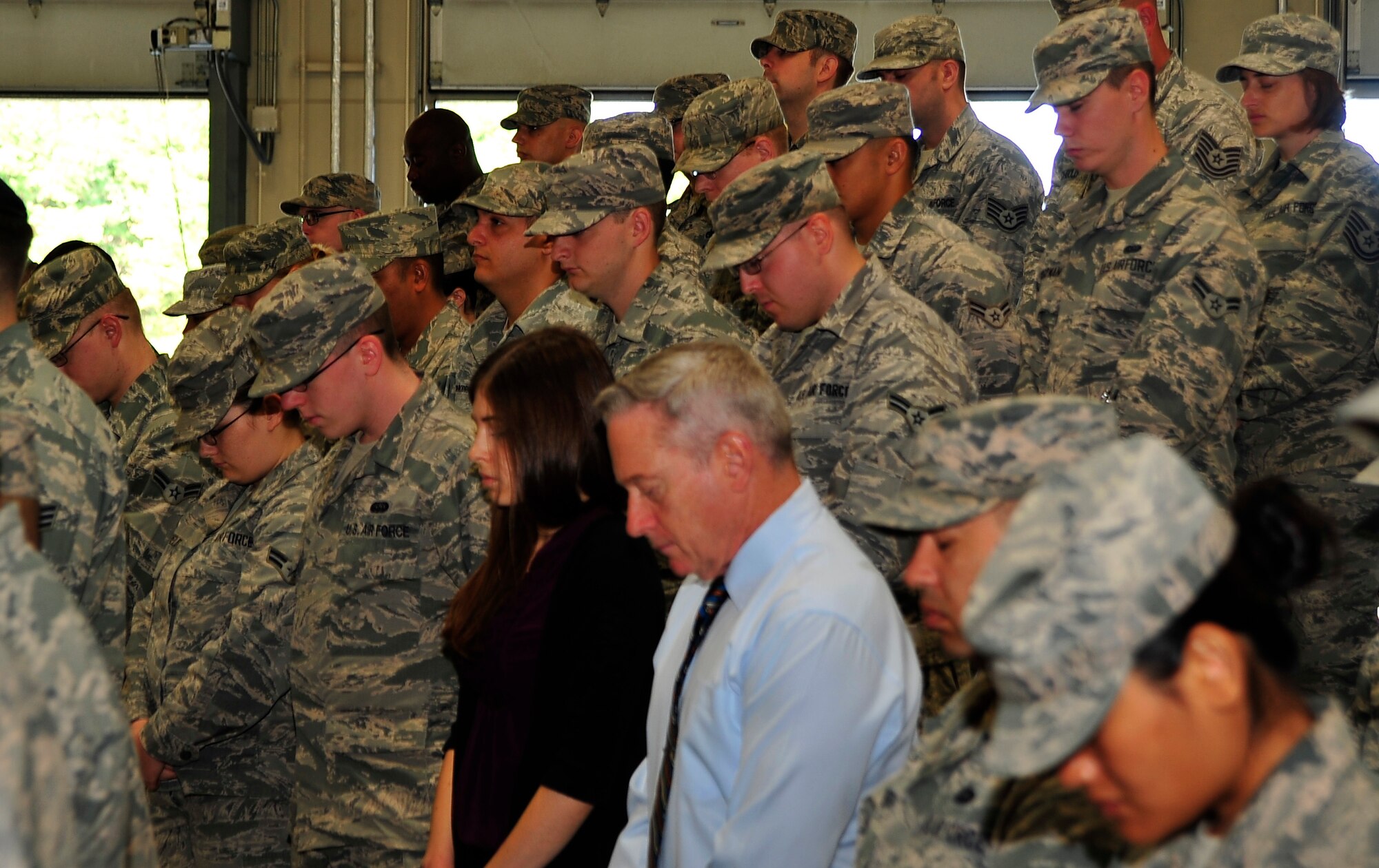 U.S. Air Force servicemembers and civilians stand and observe a moment of silence during the 9/11 ceremony at Misawa Air Base, Japan, Sept. 11th 2014.  They are reminded of that fateful day 13 years ago when the United States, Japan and the rest of the world changed forever. (U.S. Air Force photo/Tech. Sgt. April Quintanilla)
