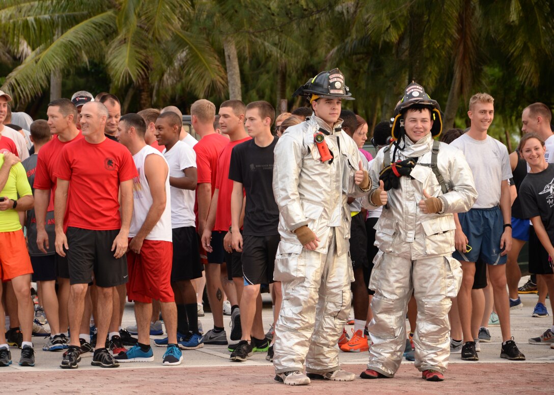 Airmen from the 36th Civil Engineer Squadron pose for a photo before running in the Remembering our Heroes 5K in their firefighting gear at Tarague Beach Sep. 11, 2014, on Andersen Air Force Base, Guam. The Airmen wore their gear as a tribute to the firefighters that sacrificed their lives during the 9/11 tragedy. (U.S. Air Force photo by Senior Airman Cierra Presentado/Released)