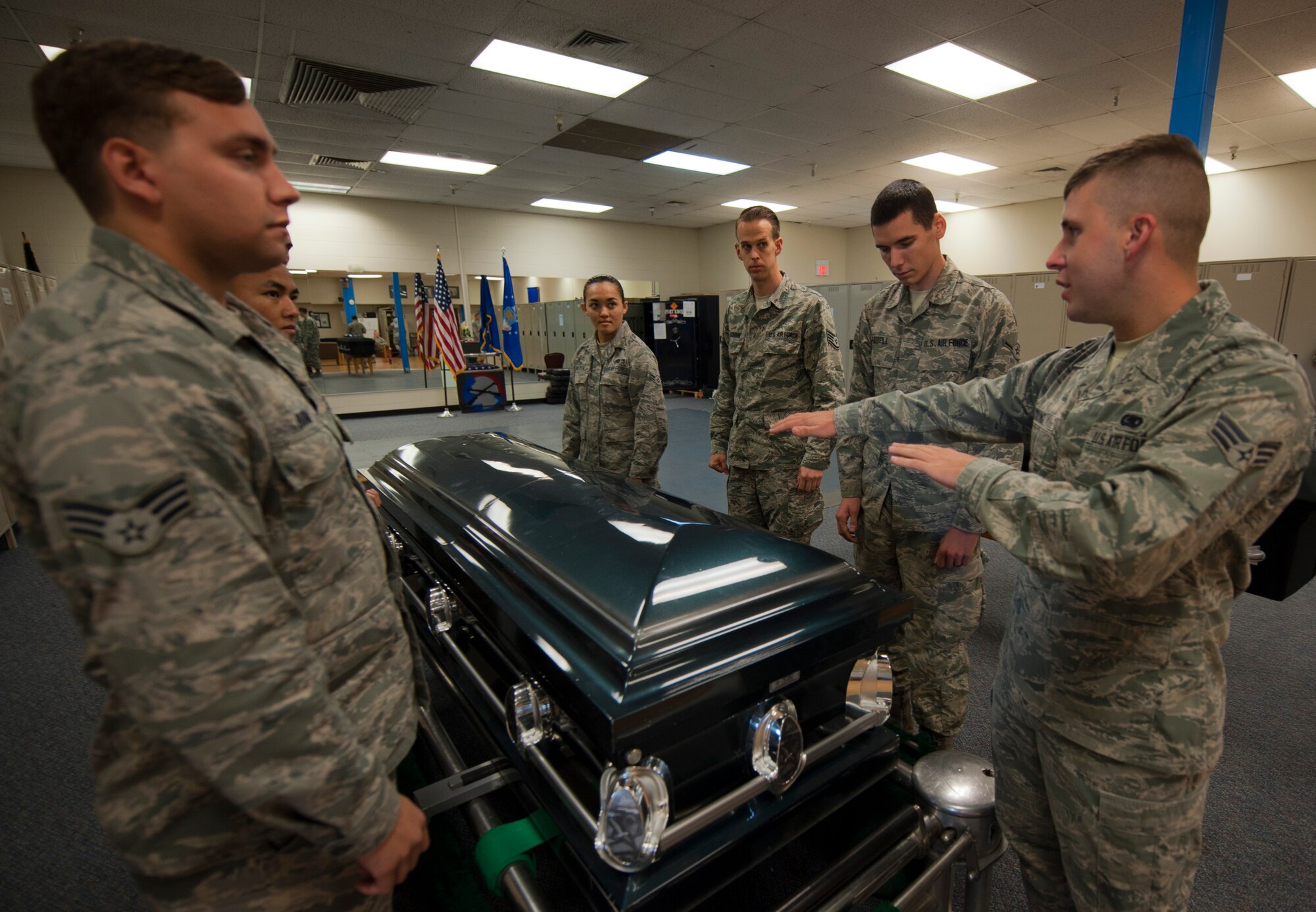 Senior Airman Alexander Young, 726th Air Control Squadron material control journeyman, explains how to move a casket during the 366th Fighter Wing Honor Guard all-call, Sept. 9, 2014, at Mountain Home Air Force Base, Idaho. The targeted audience for the All-Call ranges from Airman Basic through Staff Sergeant assigned to 366 FW and tenant units. (U.S. Air Force photo by Staff. Sgt. Roy Lynch III/RELEASED)