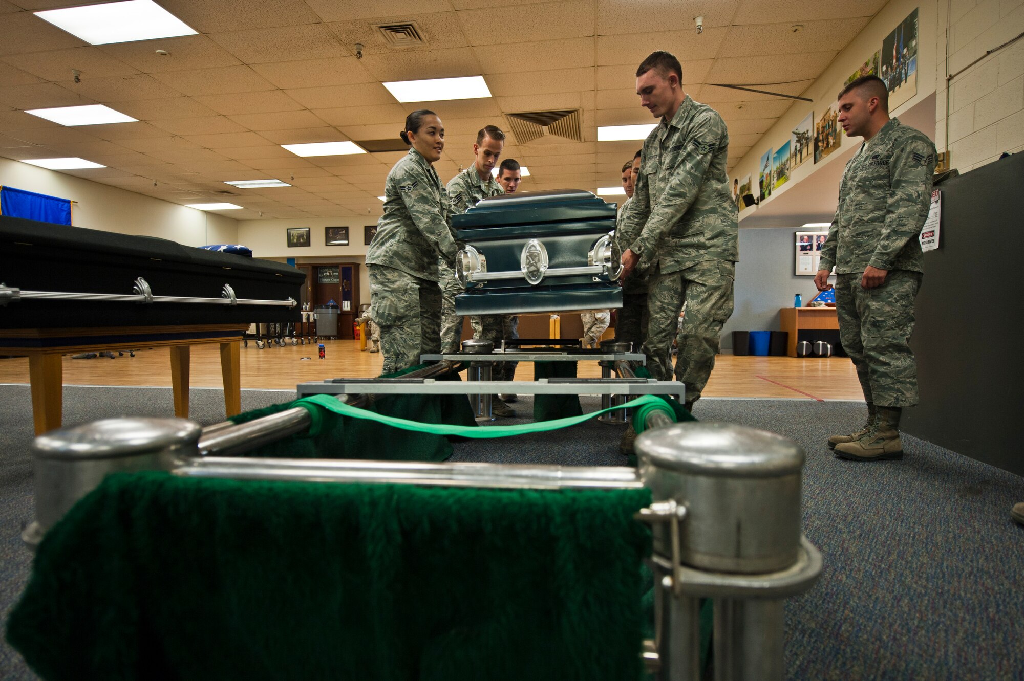 Mountain Home Air Force Base, Idaho Honor Guardsmen prepare to move a casket during the 366th Fighter Wing Honor Guard all-call, Sept. 9, 2014. Showing Airmen what duties they will be preforming gives the Honor Guard the opportunity to establish new recruits. (U.S. Air Force photo by Staff. Sgt. Roy Lynch III/RELEASED)