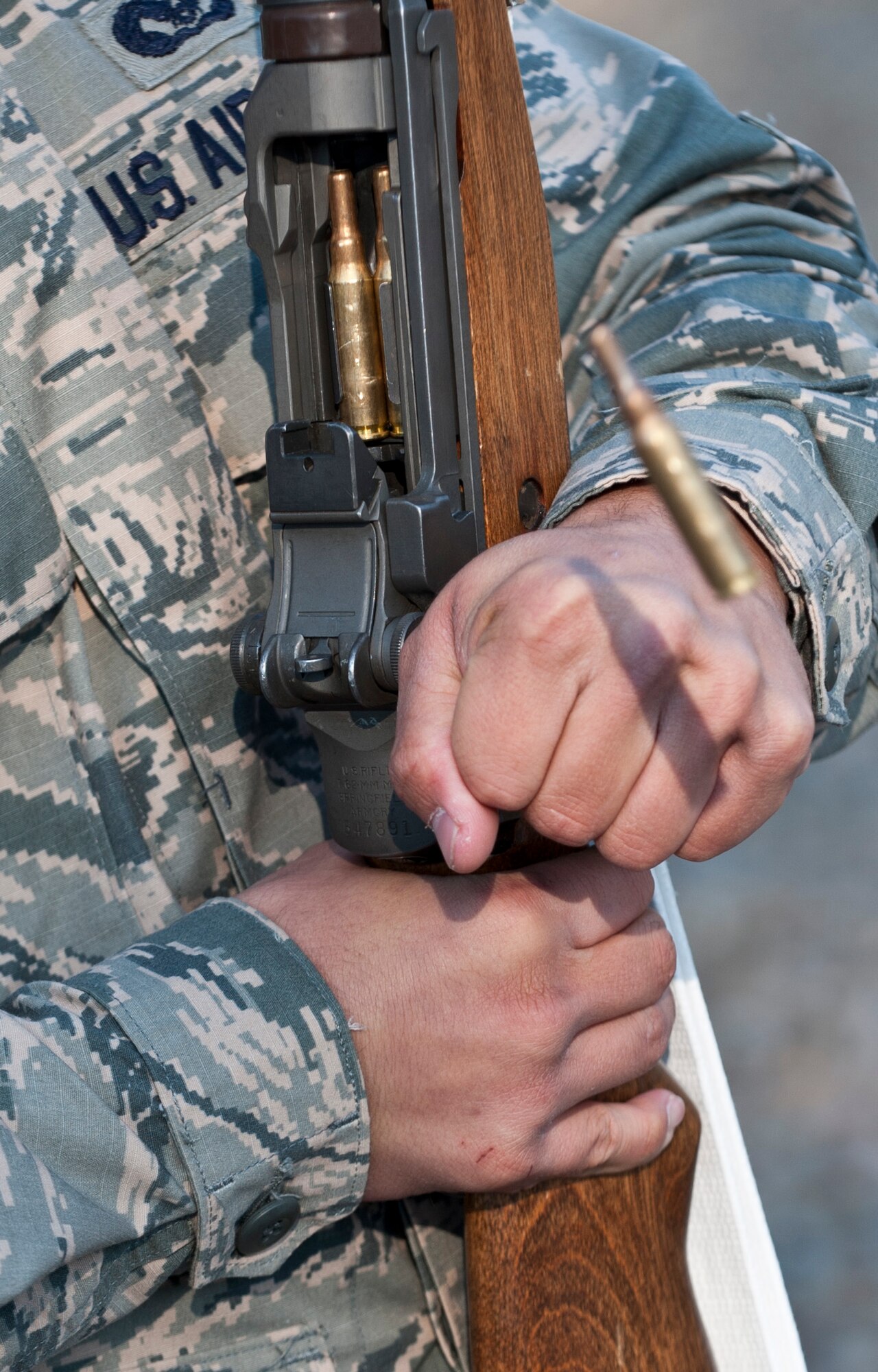 A round is ejected from a rifle during the 366th Fighter Wing Honor Guard all-call, Sept. 9, 2014, at Mountain Home Air Force Base, Idaho. Showing future Guardsmen tasks they will be preforming is just one way the all-calls are used to promote new volunteers. (U.S. Air Force photo by Staff. Sgt. Roy Lynch III/RELEASED)