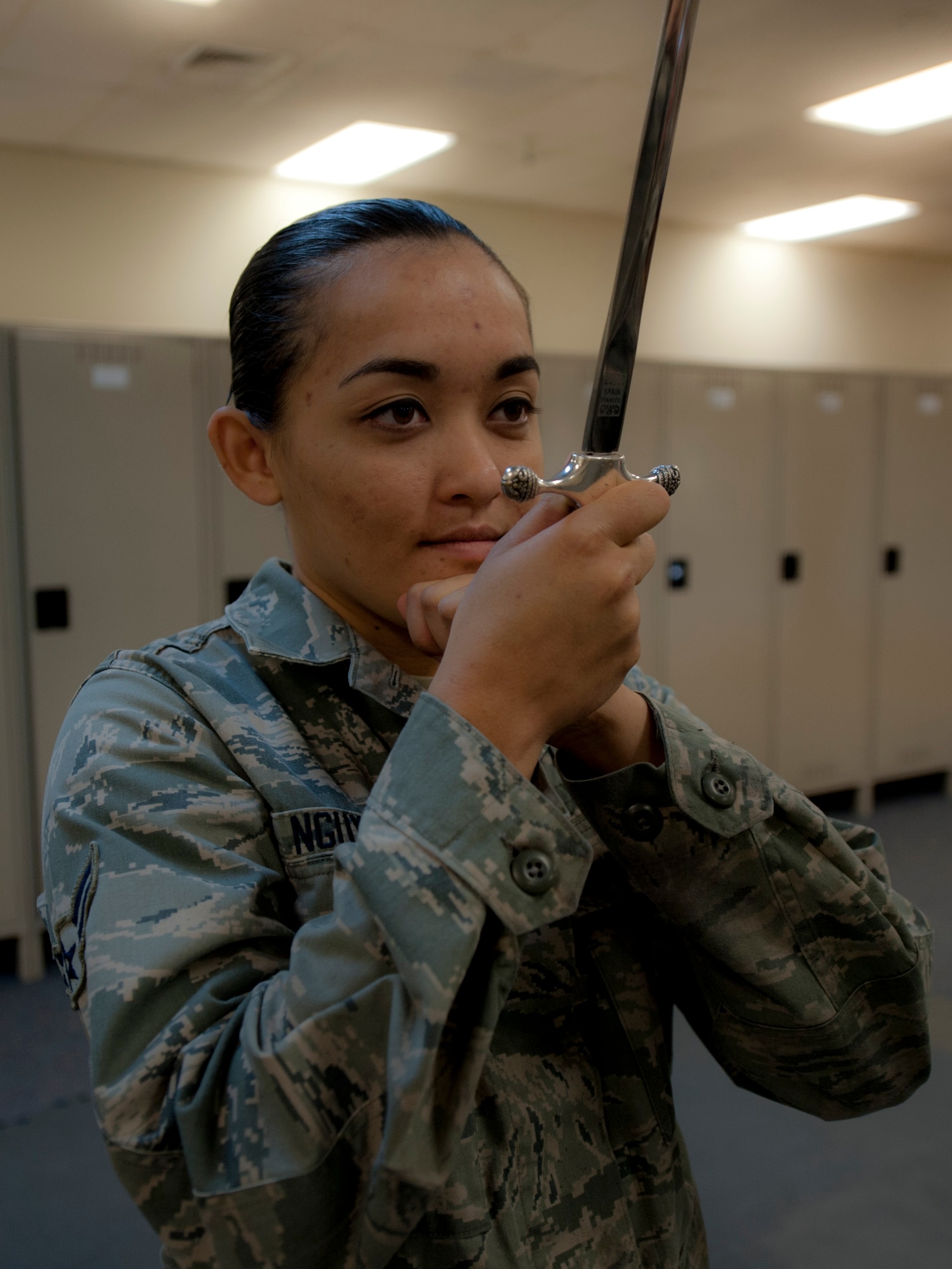 Airman 1st Class Cynthia Nguyen, 366th Component Maintenance Squadron aerospace propulsion apprentice, checks her sabers distance during the 366th Fighter Wing Honor Guard all-call, Sept. 9, 2014, at Mountain Home Air Force Base, Idaho. The all-call is a way to recruit other Airman from base to show them what they will be doing once they become members of the fully joined the MHAFB Honor Guard. (U.S. Air Force photo by Staff. Sgt. Roy Lynch III/RELEASED)
