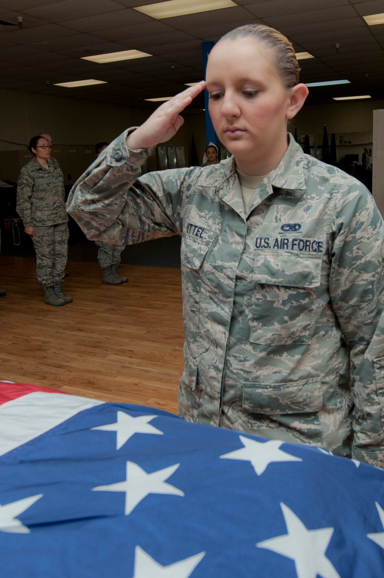 Airman 1st Class Nicole Kitter, 366th Component Maintenance Squadron aerospace propulsion apprentice, salutes the flag draped casket during the 366th Fighter Wing Honor Guard all-call, Sept. 9, 2014, at Mountain Home Air Force Base, Idaho. The all-call is a way to bring the whole Honor Guard together to practice bigger events and to get to know other Guardsmen in other flights. (U.S. Air Force photo by Staff. Sgt. Roy Lynch III/RELEASED)