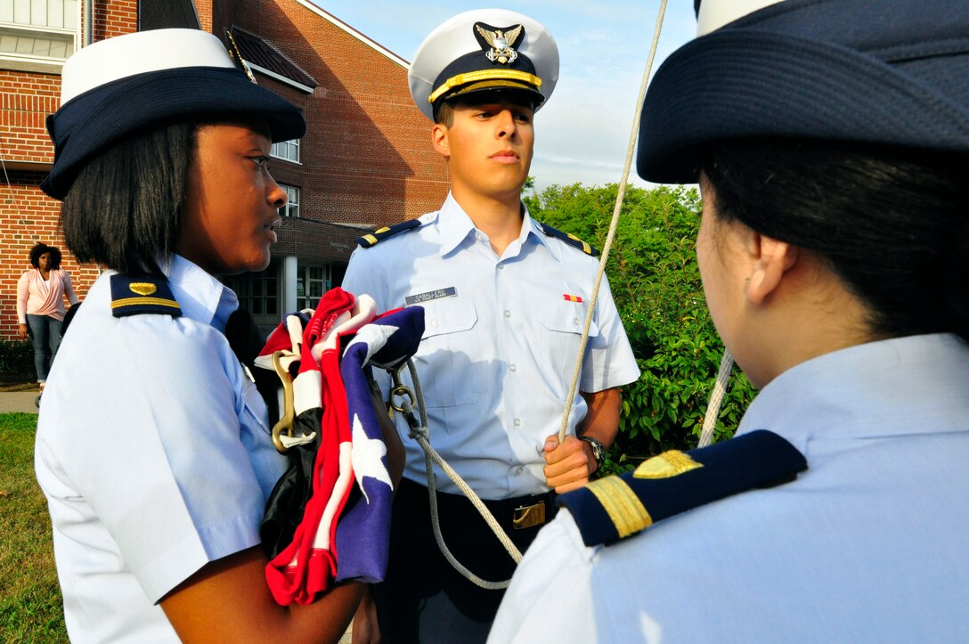 Coast Guard Ensigns Kiley Relfle, left, and Ismael Ortiz prepare to ...