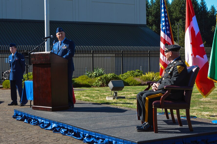 Col. Pete Stavros, Western Air Defense Sector commander, introduces Steven Saymon, retired Brooklawn Police Department police inspector, Sept. 11, 2014, during the WADS 9/11 memorial ceremony at Joint Base Lewis-McChord, Wash. During the 2001 attacks, WADS scrambled fighter aircraft from every base they could and set up air patrols over most of the major cities in America. (U.S. Air Force photo/Staff Sgt. Russ Jackson) 