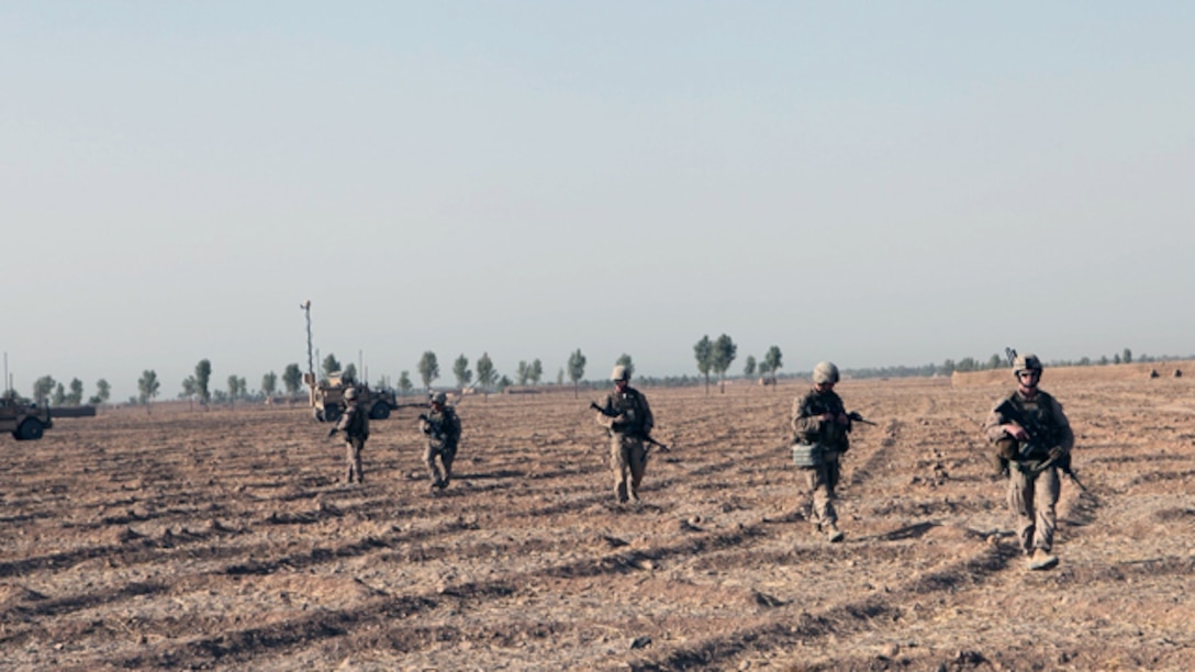 Infantry Marines with Bravo Company, 1st Battalion, 2nd Marine Regiment, look for suspicious activity during a security patrol in Helmand province, Afghanistan, Sept. 3, 2014. The operation was designed to deter enemy insurgents from operating in the southern area of Helmand province. (U.S. Marine Corps photo by Cpl. Cody Haas/ Released)