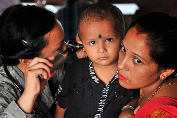 Capt. (Dr.) Enrilyn Thronson, Operation Pacific Angel-Nepal pediatrician, examines a patient at a health services outreach site in Manahari, Nepal, Sept. 9, 2014. PACANGEL supports U.S. Pacific Command’s capacity-building efforts by partnering with other governments, non-governmental agencies and multilateral militaries in the respective region to provide medical, dental, optometry and engineering assistance to their citizens. (U.S. Air Force photo by Staff Sgt. Melissa B. White)