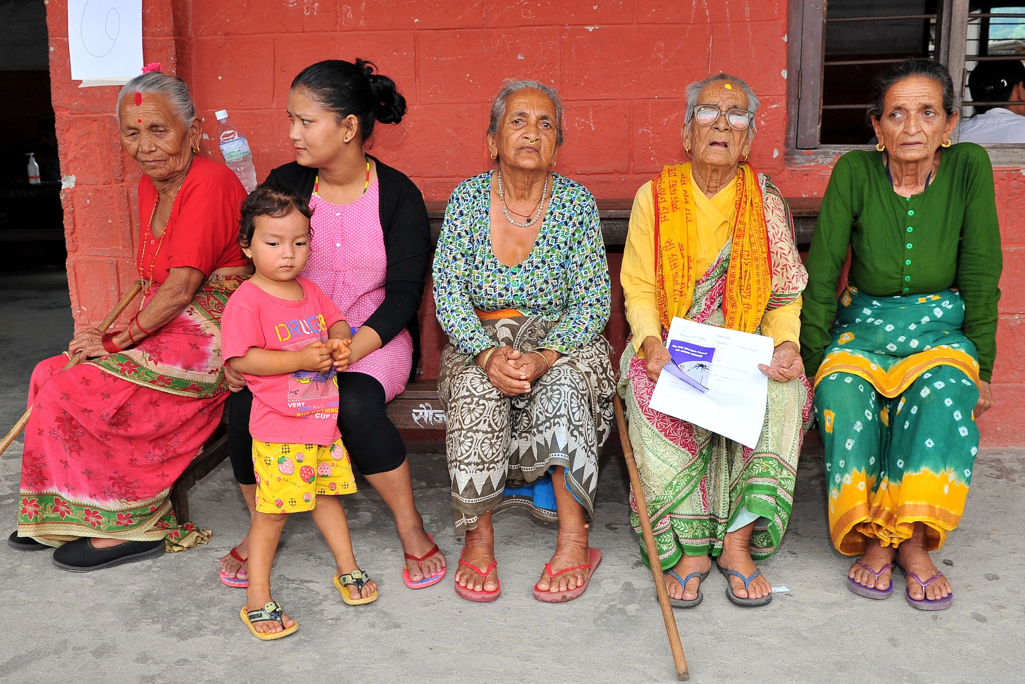 Nepalese women and children wait to be seen by Operation Pacific Angel-Nepal medical providers at a health services outreach site in Manahari, Nepal, Sept. 9, 2014. PACANGEL helps cultivate common bonds and foster goodwill between the U.S., Nepal and regional nations by conducting multilateral humanitarian assistance and civil military operations. (U.S. Air Force photo by Staff Sgt. Melissa B. White)