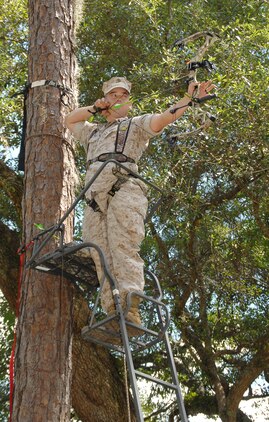 Sgt. Nathan Phelps, telephone technician, Base Telephone Office, Marine Corps Logistics Base Albany, sights in on a 3-D target while practicing with his bow, recently. MCLB Albany deer bow-hunting season begins Saturday.