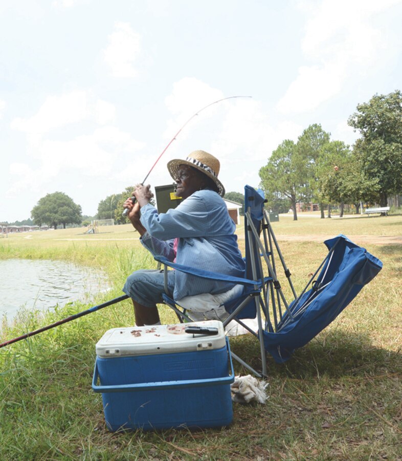 Mattie Johnson casts her fishing line into Covella Pond aboard Marine Corps Logistics Base Albany, recently. Johnson visits the pond twice a week to fish.